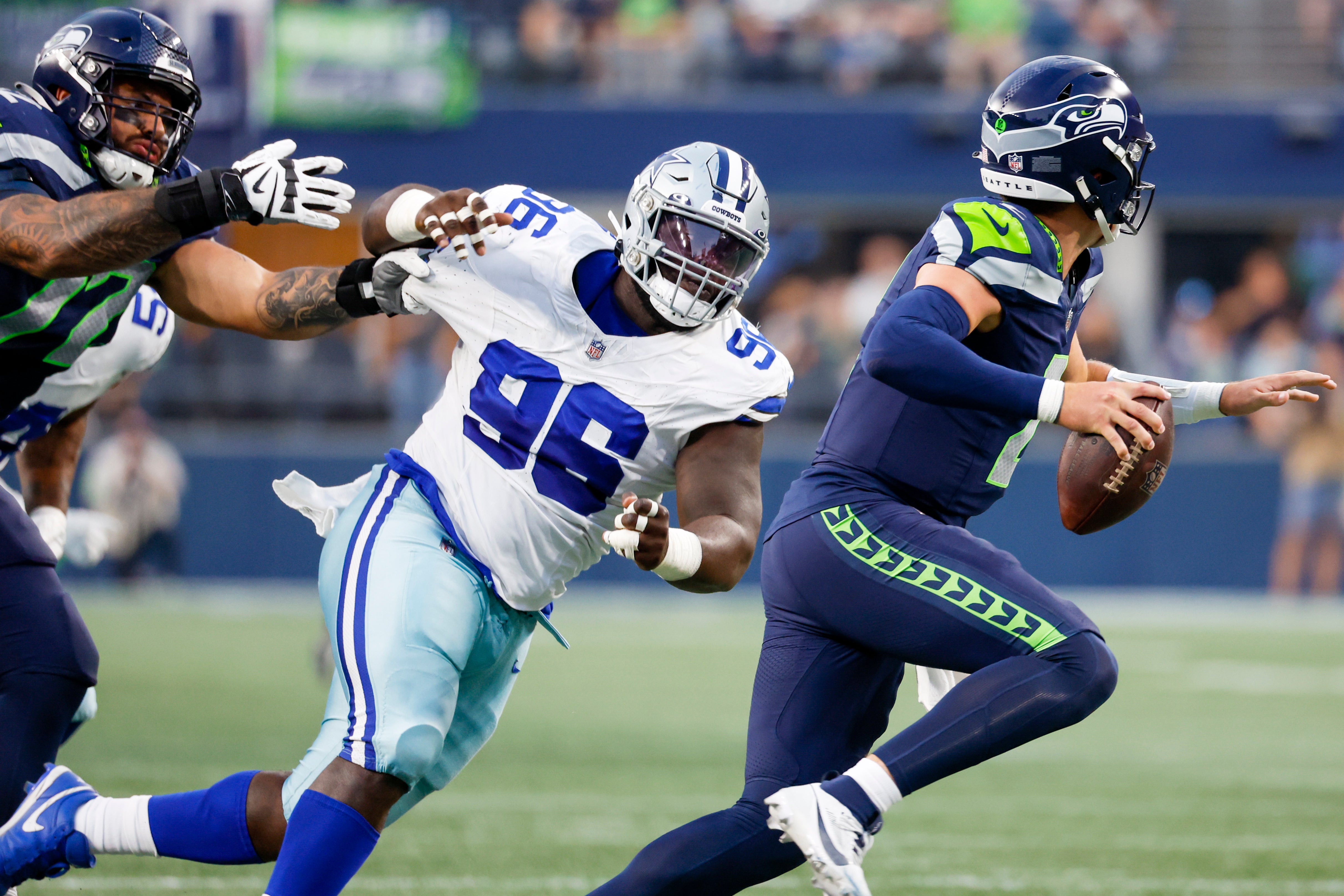 Dallas Cowboys defensive tackle Neville Gallimore (96) pressures Seattle Seahawks quarterback Drew Lock (2) while being blocked by offensive tackle Abraham Lucas (72) during the second quarter at Lumen Field. Mandatory Credit: Joe Nicholson-USA TODAY Sports