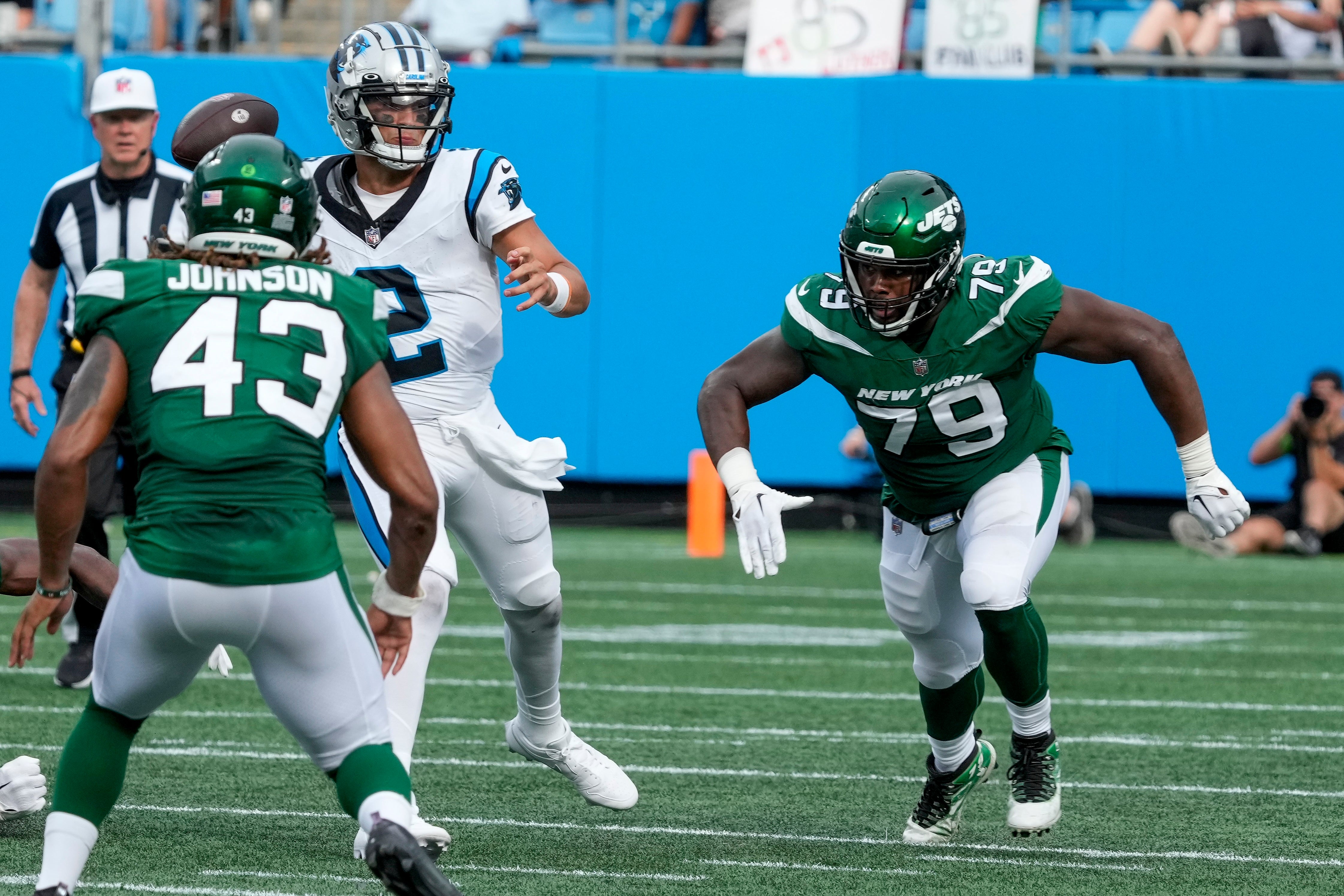 Carolina Panthers quarterback Matt Corral (2) tries for a throw under pressure from New York Jets defensive tackle Tanzel Smart (79) during the second half at Bank of America Stadium.
