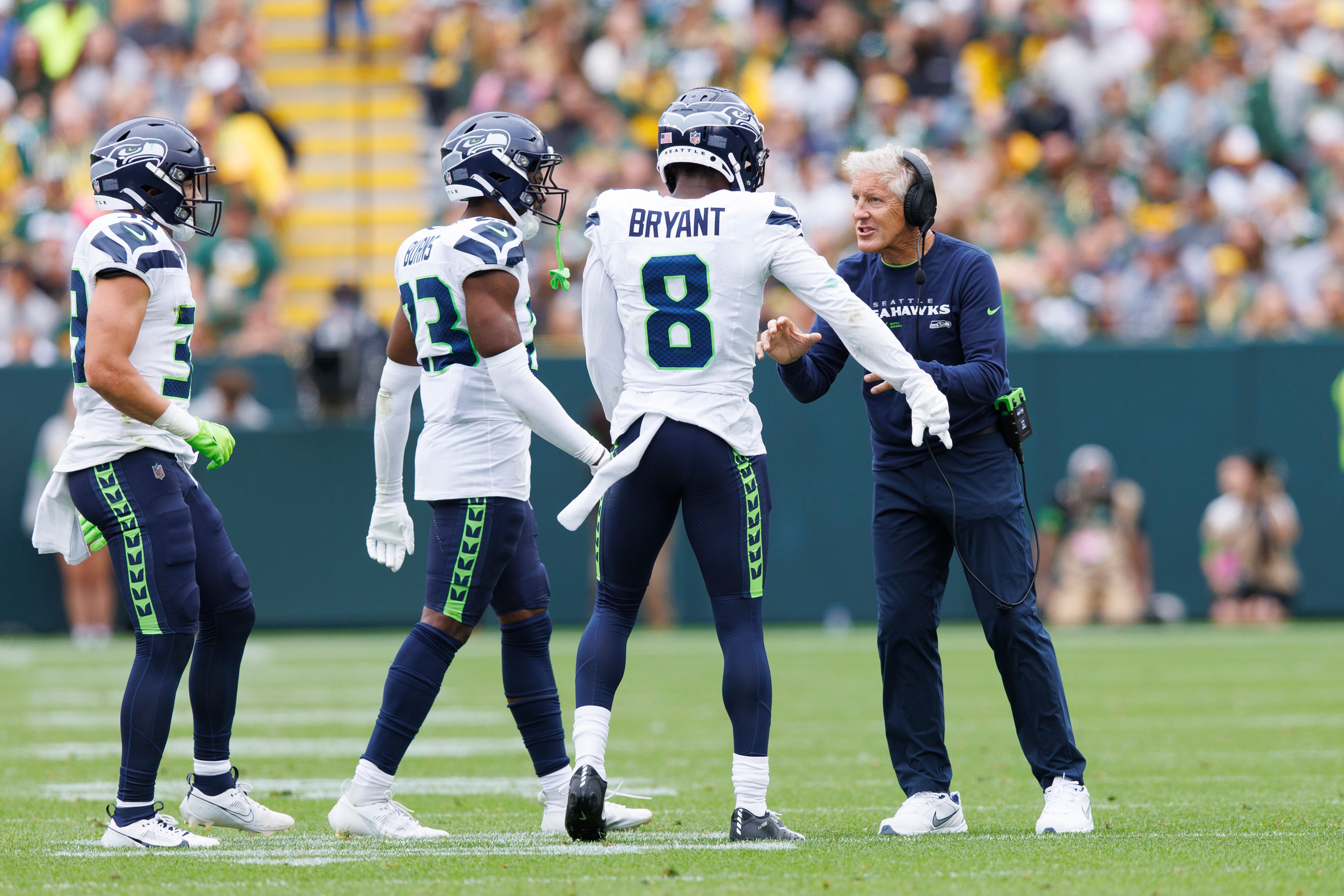 Aug 26, 2023; Green Bay, Wisconsin, USA; Seattle Seahawks head coach Pete Carroll talks with cornerback Coby Bryant (8) and cornerback Artie Burns (23) during the second quarter against the Green Bay Packers at Lambeau Field. Mandatory Credit: Jeff Hanisch-USA TODAY Sports