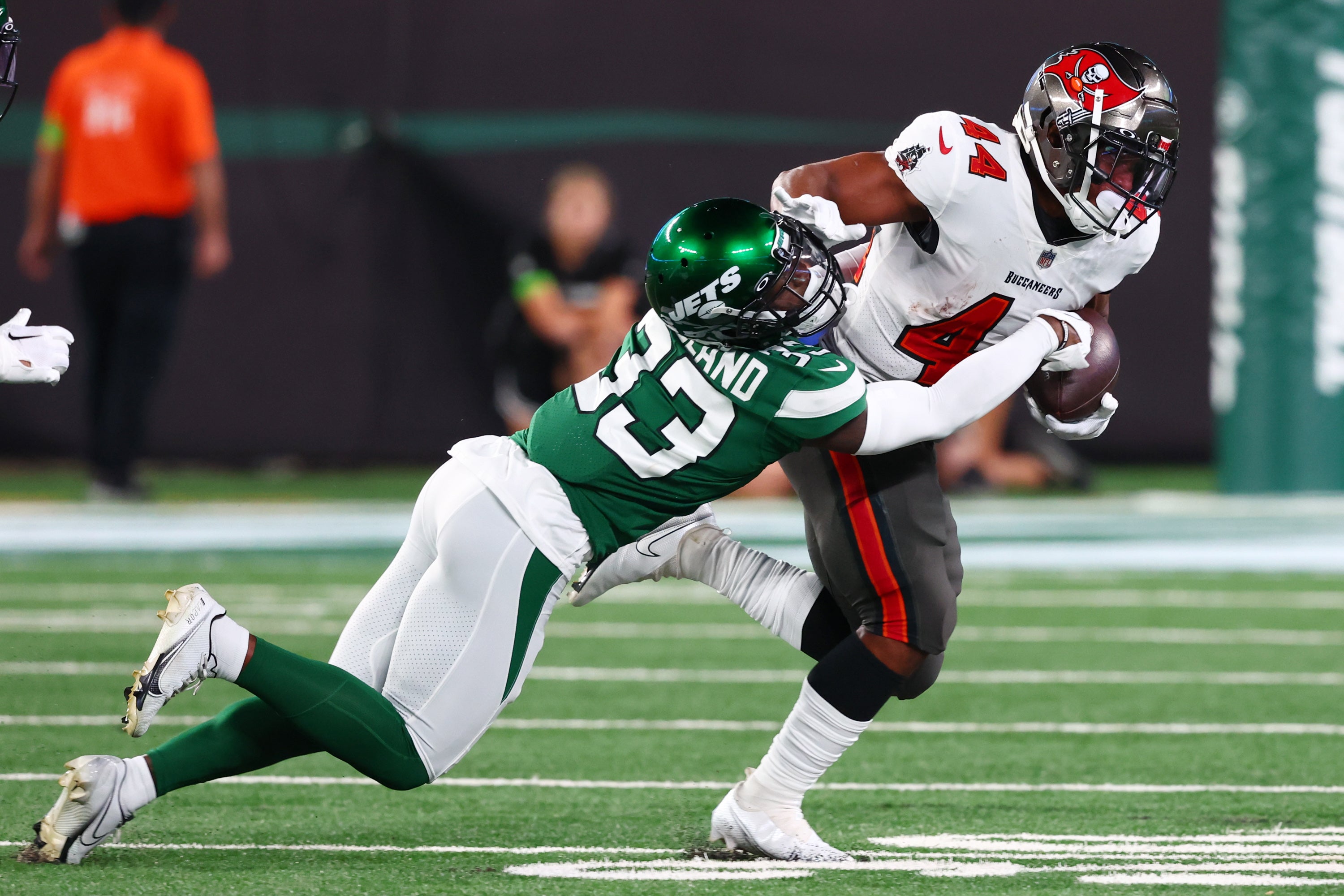 Aug 19, 2023; East Rutherford, New Jersey, USA; Tampa Bay Buccaneers running back Sean Tucker (44) runs with the ball while New York Jets cornerback Jimmy Moreland (33) attempts to tackle him during the first half at MetLife Stadium. Mandatory Credit: Ed Mulholland-USA TODAY Sports