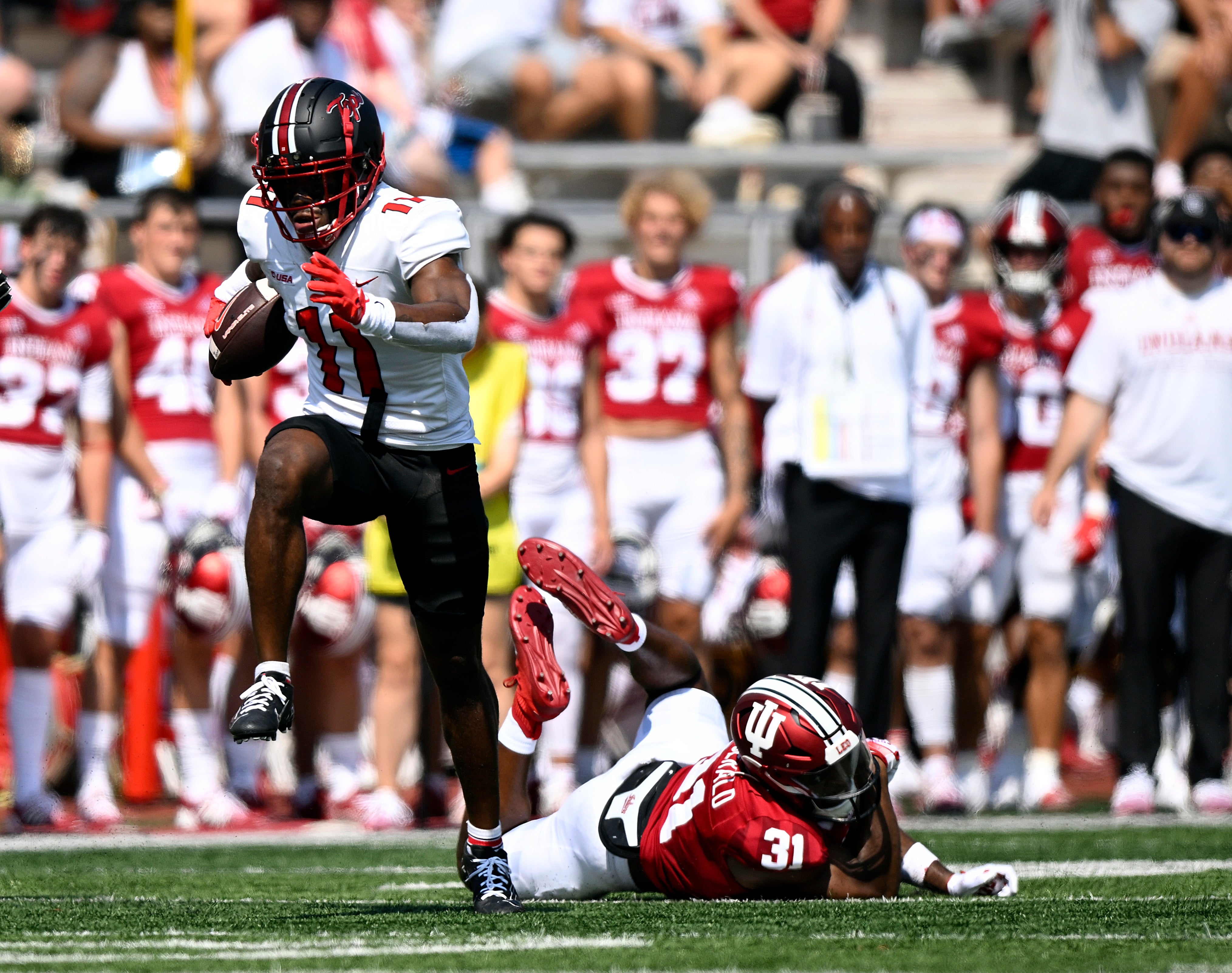 Sep 17, 2022; Bloomington, Indiana, USA; Western Kentucky Hilltoppers wide receiver Malachi Corley (11) dodges a tackle by Indiana Hoosiers defensive back Bryant Fitzgerald (31) during the first quarter at Memorial Stadium. Mandatory Credit: Marc Lebryk-USA TODAY Sports  