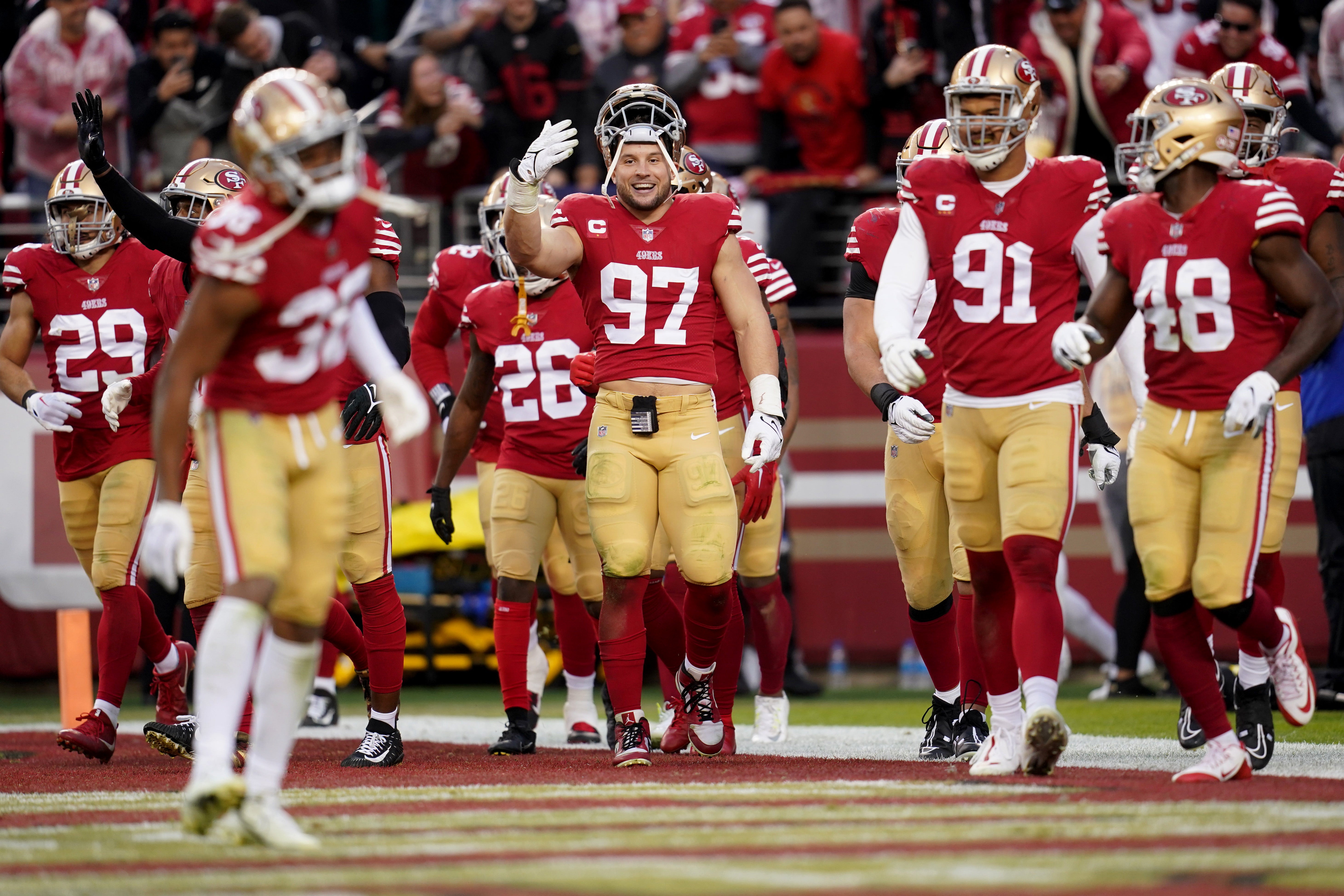 Jan 14, 2023; Santa Clara, California, USA; San Francisco 49ers defensive end Nick Bosa (97) gestures toward cornerback Deommodore Lenoir (38) after his interception in the fourth quarter of a wild card game against the Seattle Seahawks at Levi's Stadium. Mandatory Credit: Cary Edmondson-USA TODAY Sports
