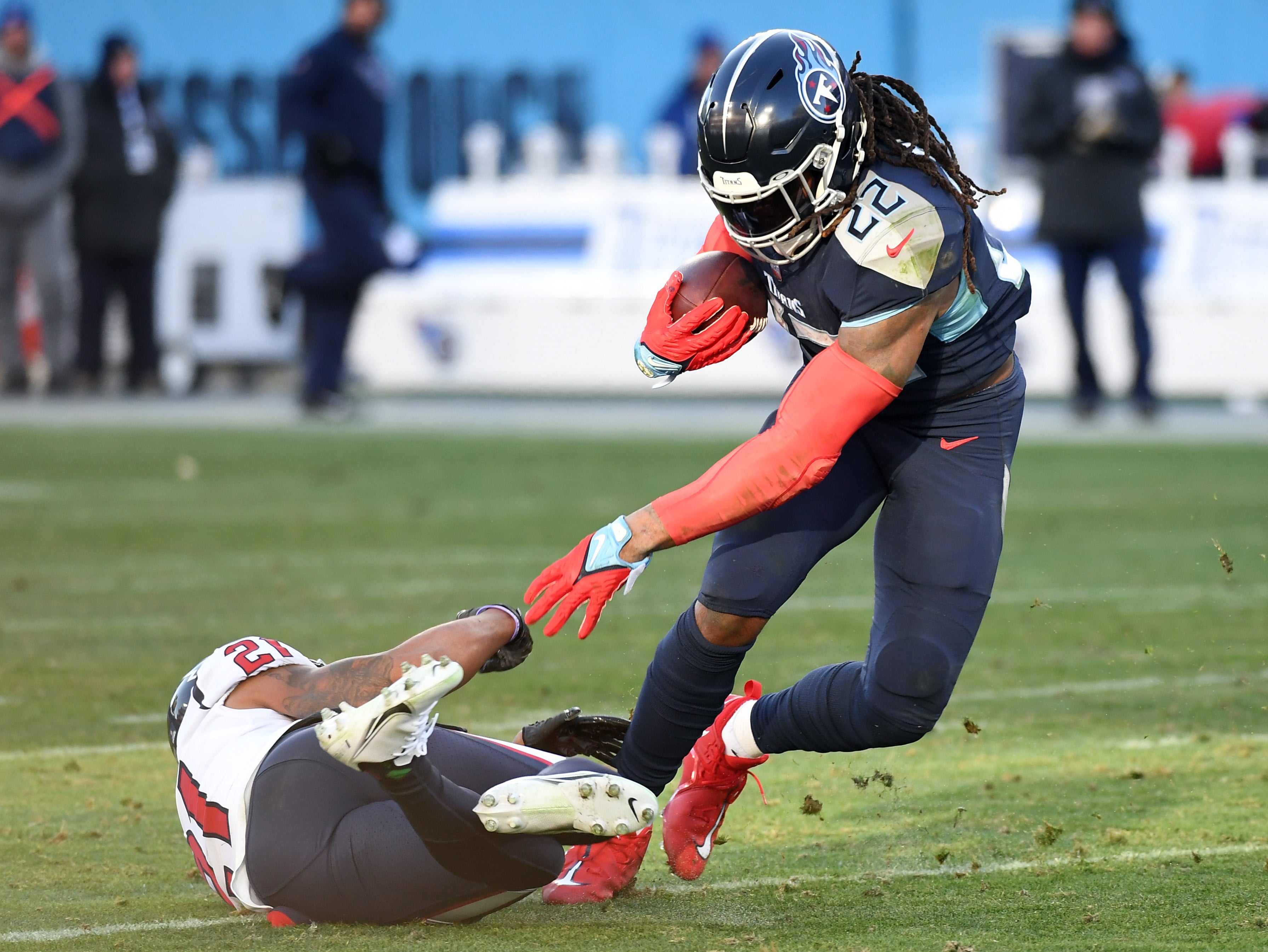 Tennessee Titans running back Derrick Henry (22) fights off a tackle attempt from Houston Texans cornerback Steven Nelson (21) during the second half at Nissan Stadium. Mandatory Credit: Christopher Hanewinckel-USA TODAY Sports