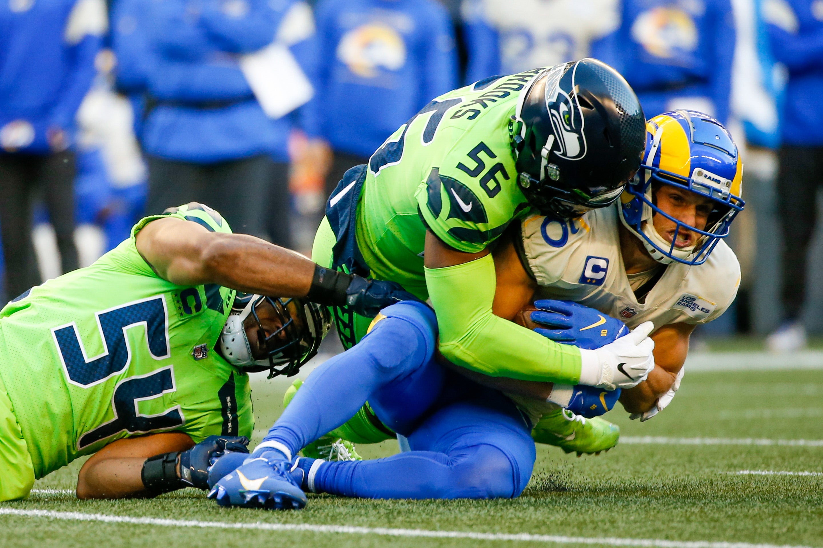 Oct 7, 2021; Seattle, Washington, USA; Los Angeles Rams wide receiver Cooper Kupp (10) is tackled by Seattle Seahawks middle linebacker Bobby Wagner (54) and linebacker Jordyn Brooks (56) after making a reception during the first quarter at Lumen Field. Mandatory Credit: Joe Nicholson-USA TODAY Sports