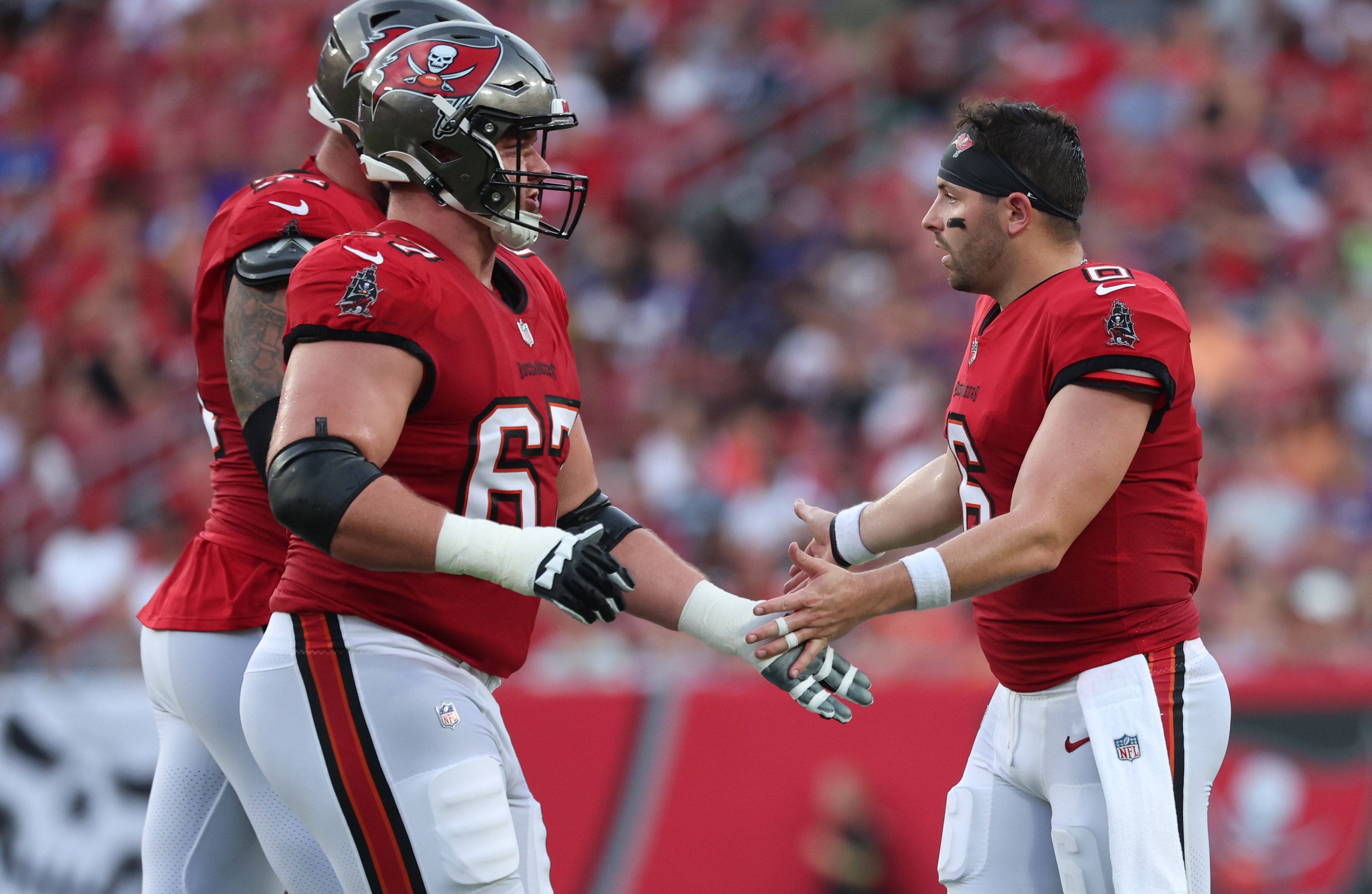 Aug 26, 2023; Tampa, Florida, USA; Tampa Bay Buccaneers quarterback Baker Mayfield (6) congratulates guard Luke Goedeke (67) after they scored a touchdown against the Baltimore Ravens during the first quarter at Raymond James Stadium. Mandatory Credit: Kim Klement Neitzel-USA TODAY Sports