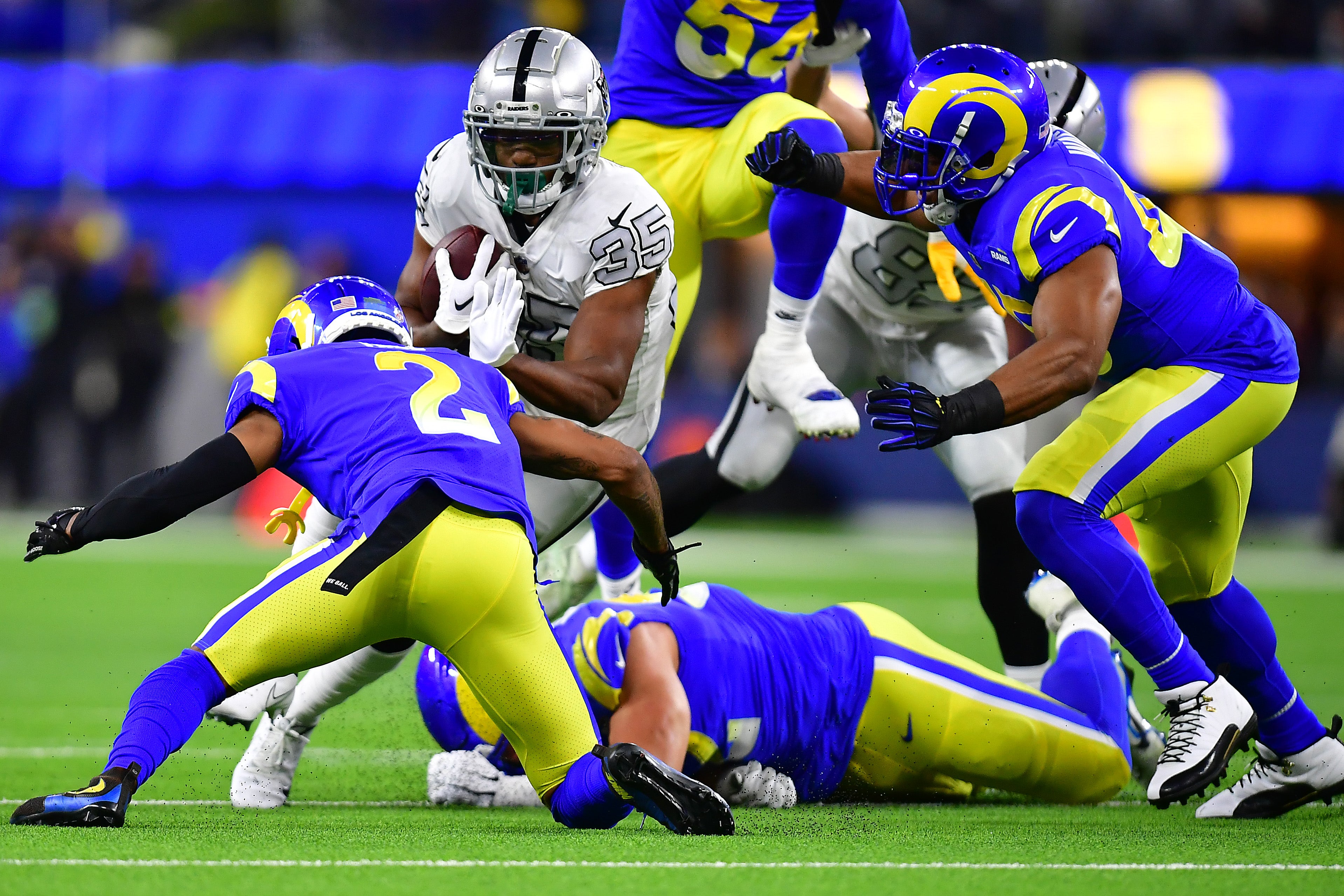 Dec 8, 2022; Inglewood, California, USA; Las Vegas Raiders running back Zamir White (35) runs the ball against Los Angeles Rams cornerback Troy Hill (2) during the first half at SoFi Stadium. Mandatory Credit: Gary A. Vasquez-USA TODAY Sports