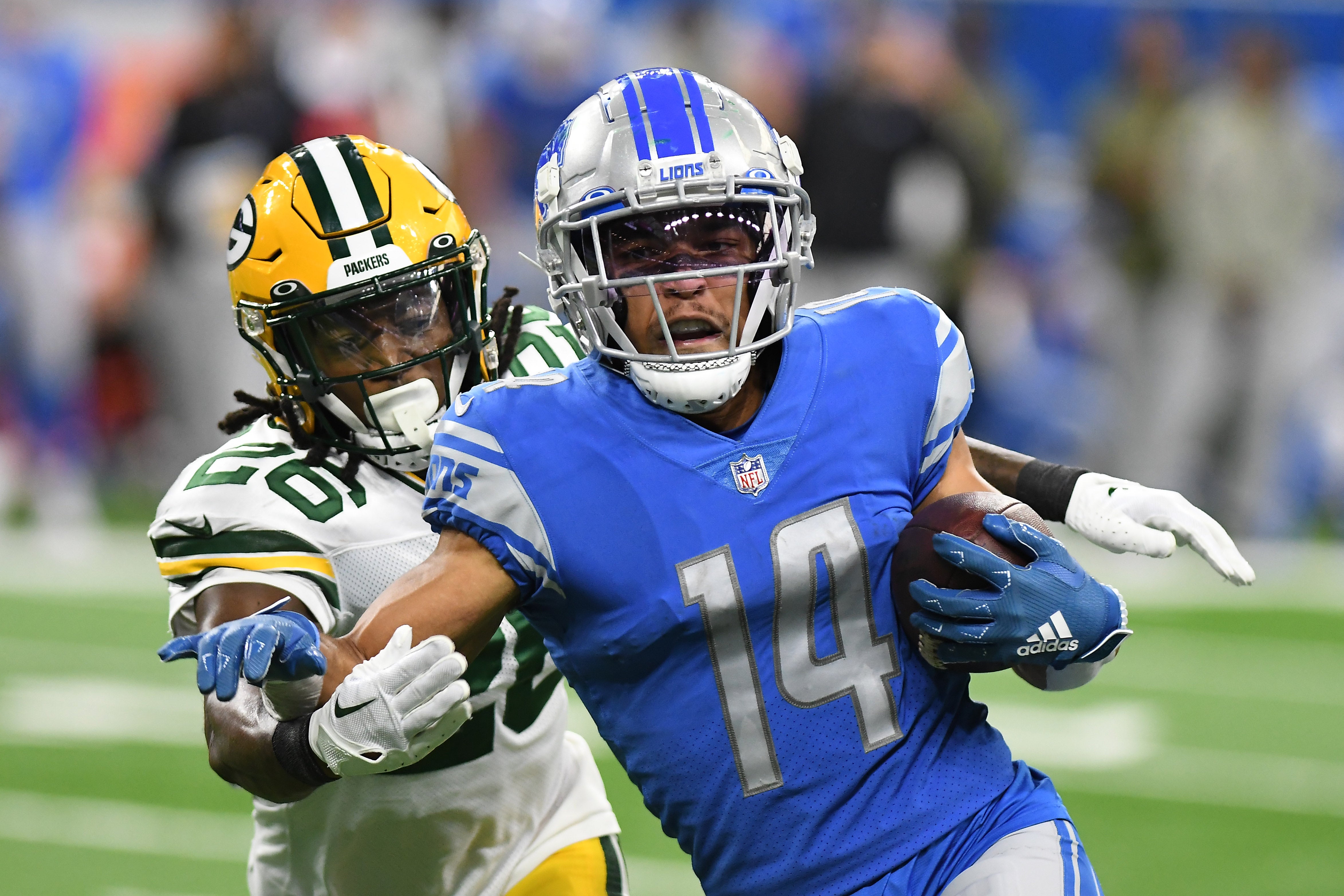 Nov 6, 2022; Detroit, Michigan, USA; Detroit Lions wide receiver Amon-Ra St. Brown (14) heads upfield past Green Bay Packers safety Darnell Savage (26) after catching a pass in the third quarter at Ford Field.  Lon Horwedel-USA TODAY Sports