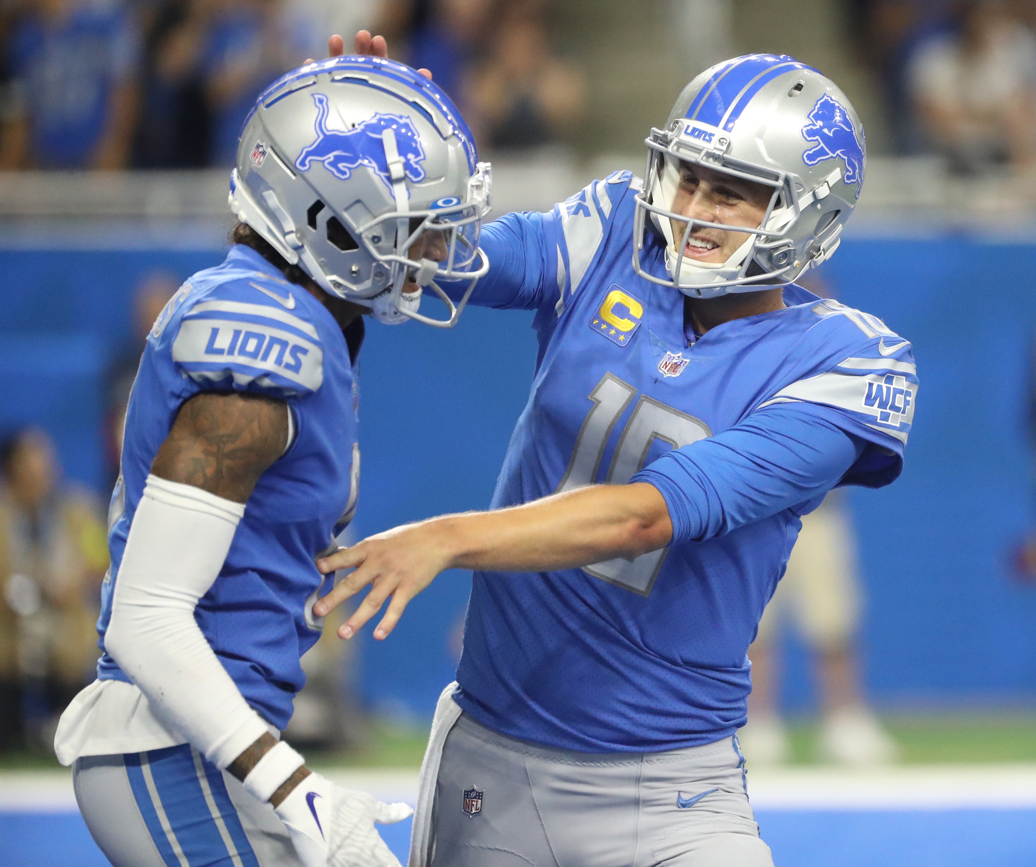 Sep 18, 2022; Detroit, Michigan, USA; Detroit Lions wide receiver Josh Reynolds (8) and quarterback Jared Goff (16) celebrate after a touchdown against the Washington Commanders during first half action at Ford Field. Kirthmon F. Dozier-USA TODAY Sports