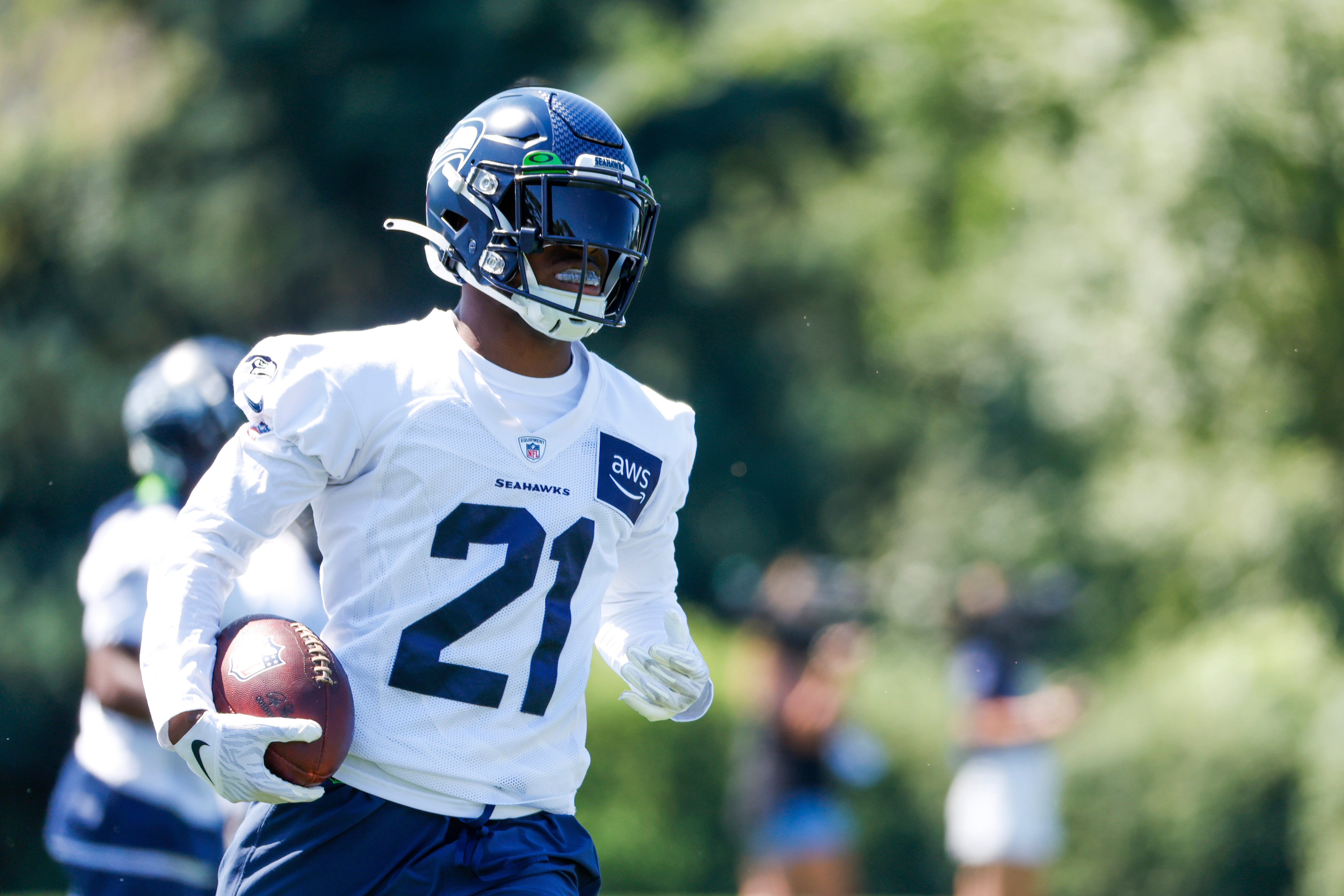 Jul 28, 2023; Renton, WA, USA; Seattle Seahawks cornerback Devon Witherspoon (21) returns an interception during training camp practice at the Virginia Mason Athletic Center. Mandatory Credit: Joe Nicholson-USA TODAY Sports