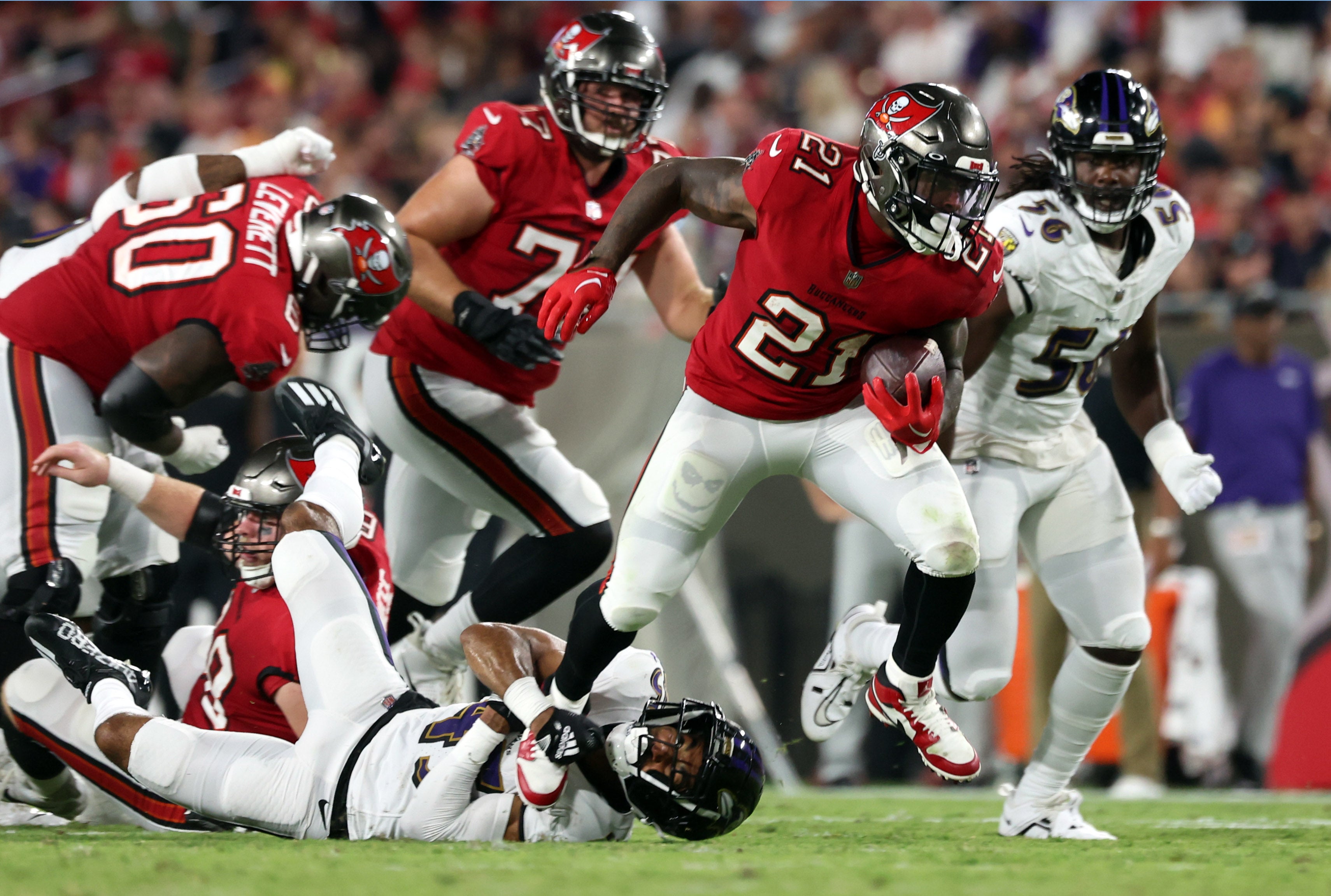 Aug 26, 2023; Tampa, Florida, USA; Tampa Bay Buccaneers running back Ke'Shawn Vaughn (21) runs past Baltimore Ravens cornerback Daryl Worley (41) during the second quarter at Raymond James Stadium. Mandatory Credit: Kim Klement Neitzel-USA TODAY Sports