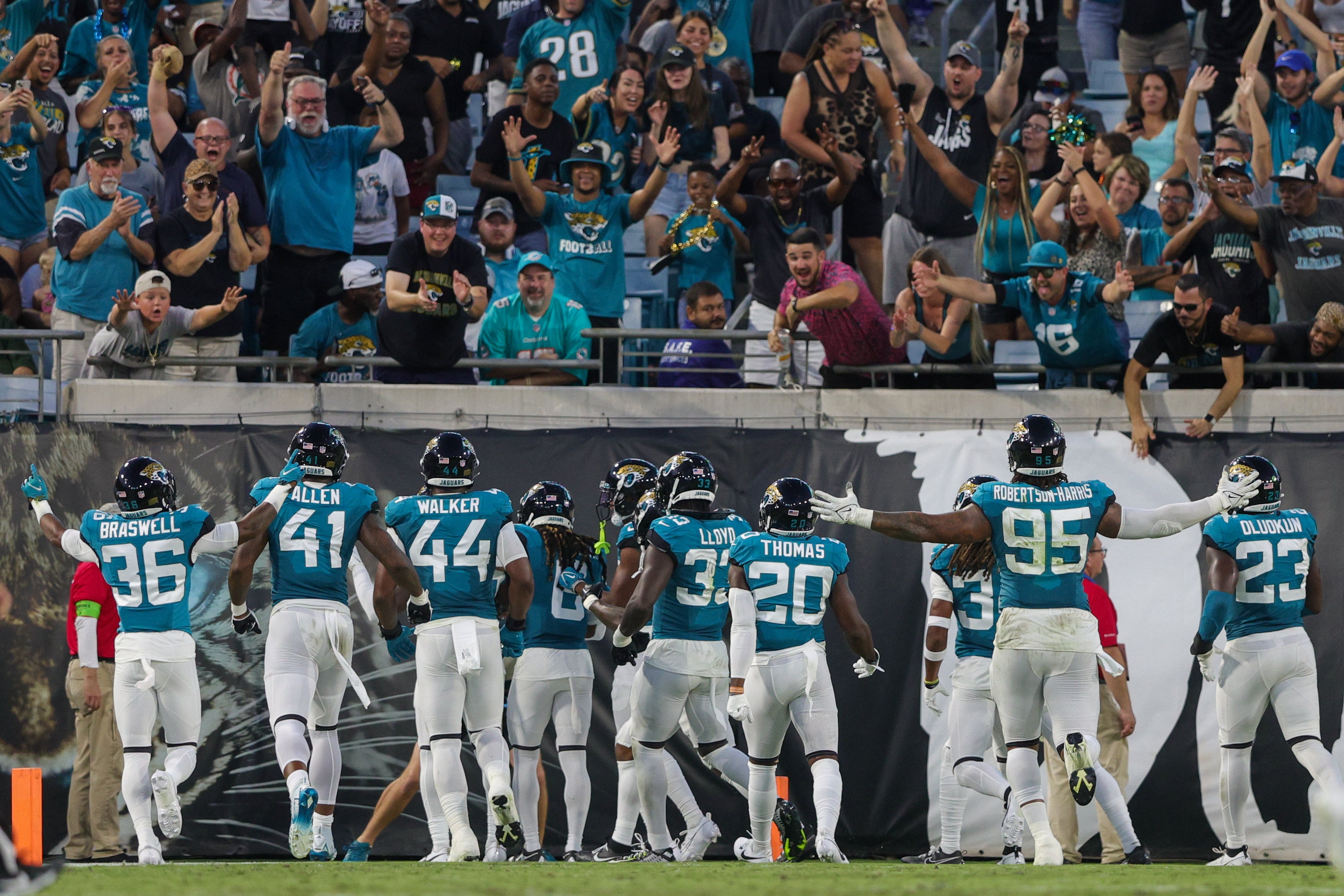 Aug 26, 2023; Jacksonville, Florida, USA; Jacksonville Jaguars linebacker Josh Allen (41) and linebacker Travon Walker (44) celebrate after an interception against the Miami Dolphins in the second quarter at EverBank Stadium.