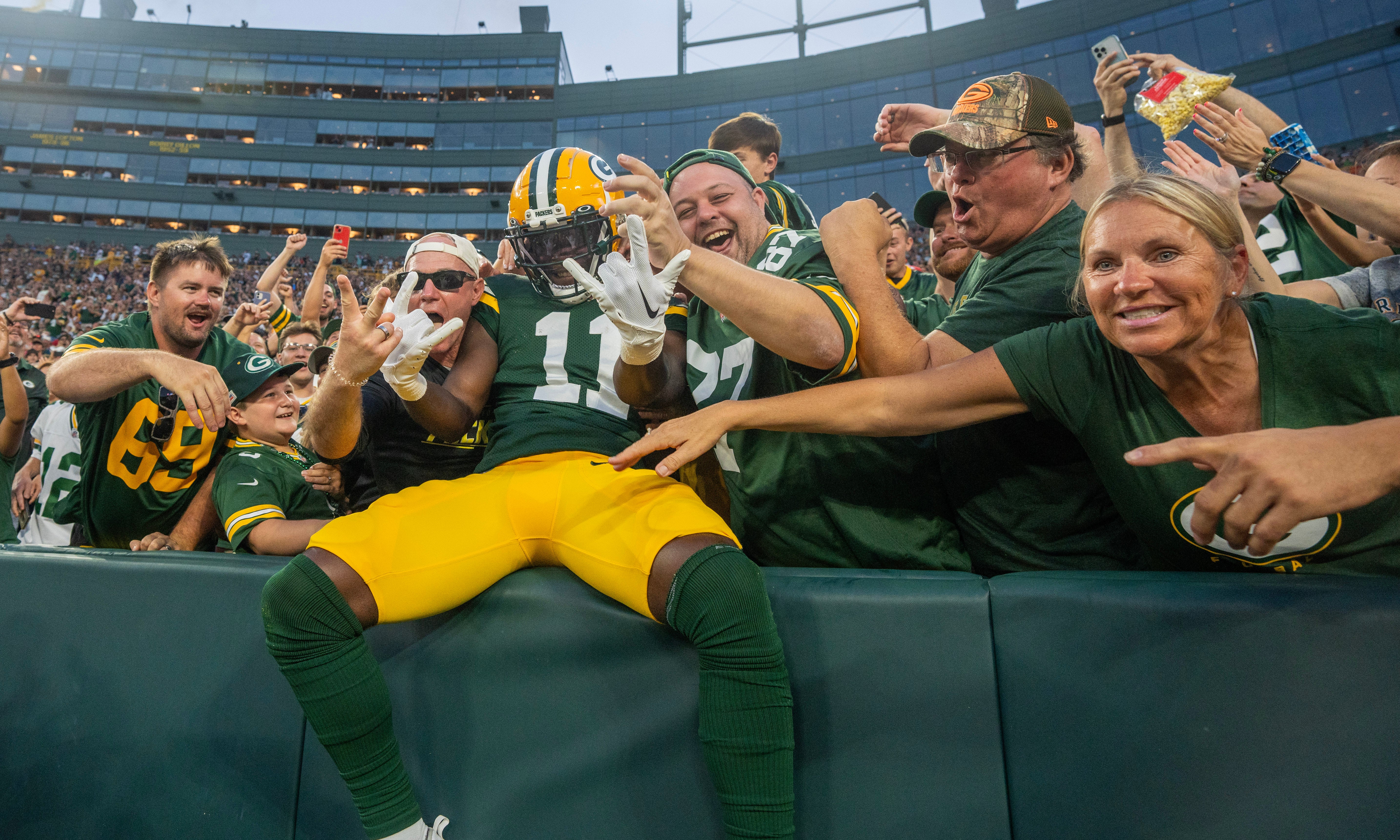 Aug 19, 2023; Green Bay, WI, USA; Green Bay Packers wide receiver Jayden Reed (11) celebrates his 19-yard touchdown reception with a Lambeau Leap during the second quarter of their preseason game against the New England Patriots at Lambeau Field. Mandatory Credit: Mark Hoffman-USA TODAY Sports