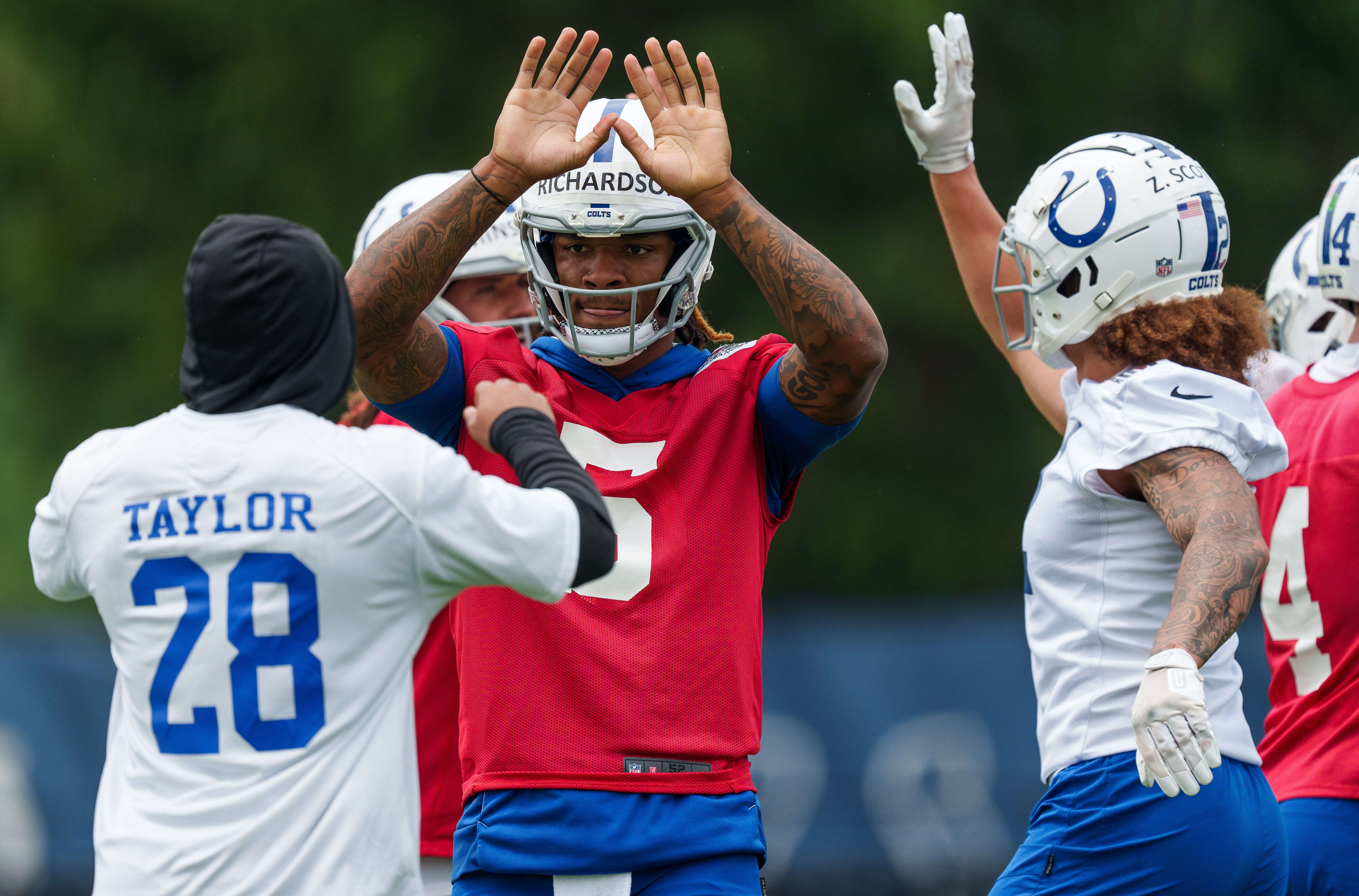June 14, 2023; Indianapolis, IN, USA; Indianapolis Colts quarterback Anthony Richardson (5) gives a high-five to Colts running back Jonathan Taylor (28) on Wednesday, June 14, 2023, during mandatory minicamp at the Indiana Farm Bureau Football Center in Indianapolis.