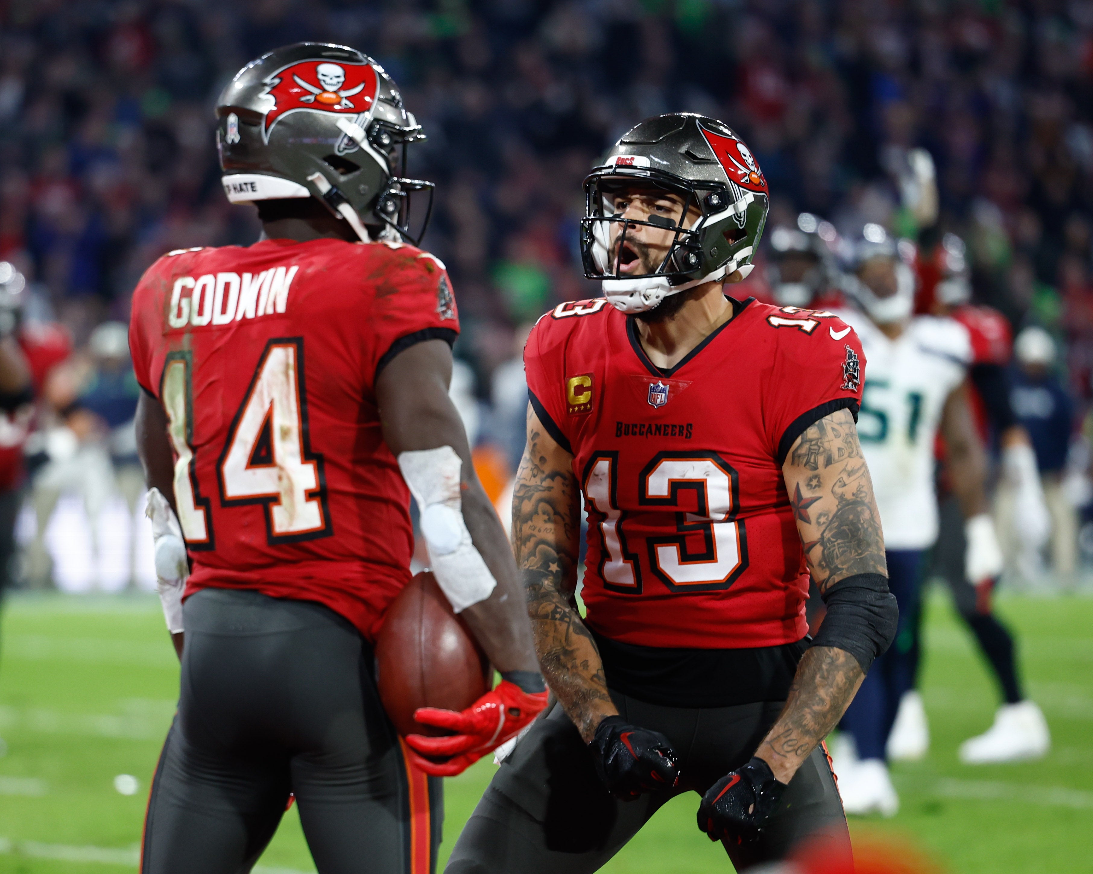 Nov 13, 2022; Munich, Germany, DEU; Tampa Bay Buccaneers wide receiver Chris Godwin (14) celebrates his touchdown with teammate wide receiver Mike Evans (13) against the Seattle Seahawks during the fourth quarter of an International Series game at Allianz Arena. Mandatory Credit: Douglas DeFelice-USA TODAY Sports