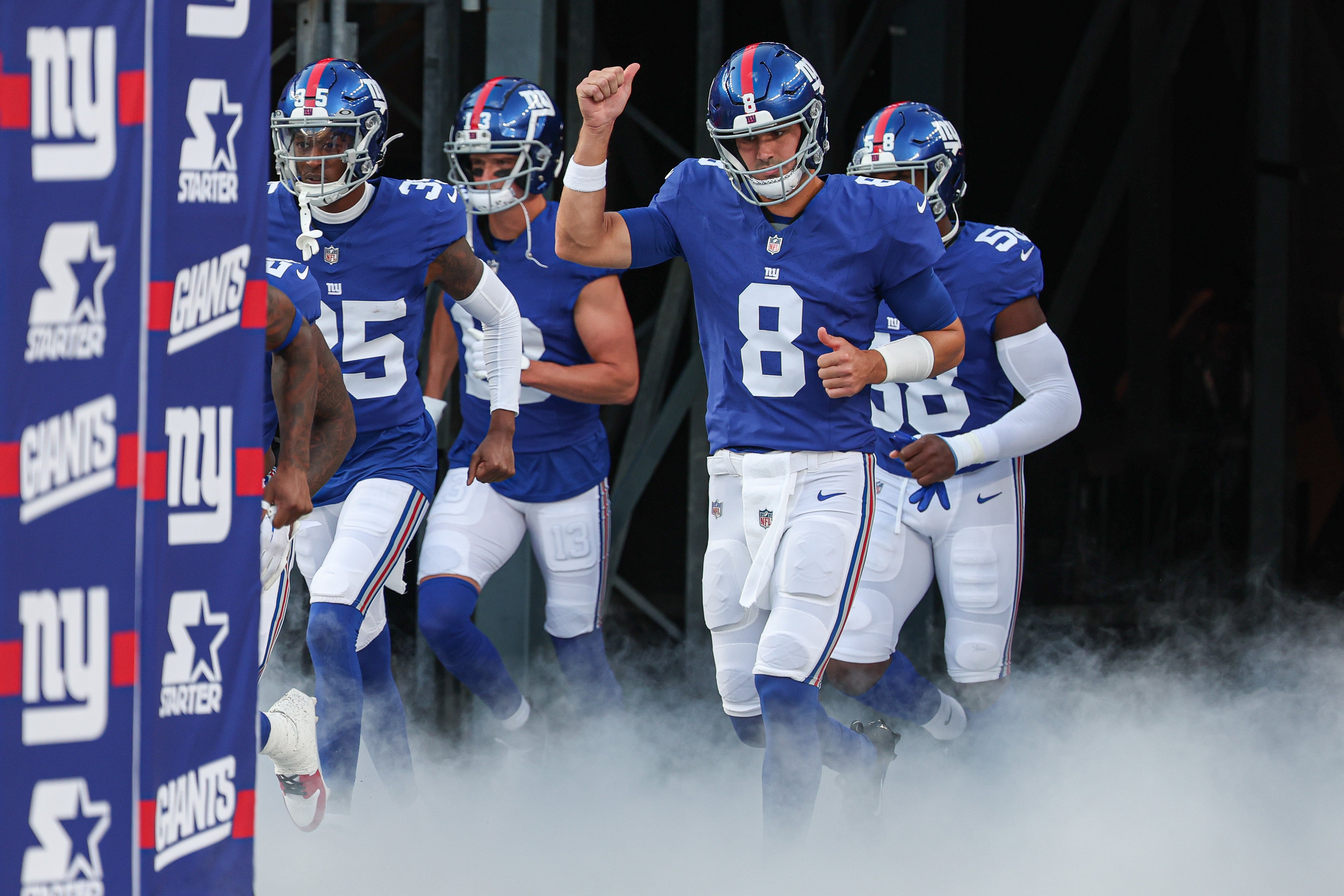 Aug 18, 2023; East Rutherford, New Jersey, USA; New York Giants quarterback Daniel Jones (8) run on to the field before the game against the Carolina Panthers at MetLife Stadium. Mandatory Credit: Vincent Carchietta-USA TODAY Sports
