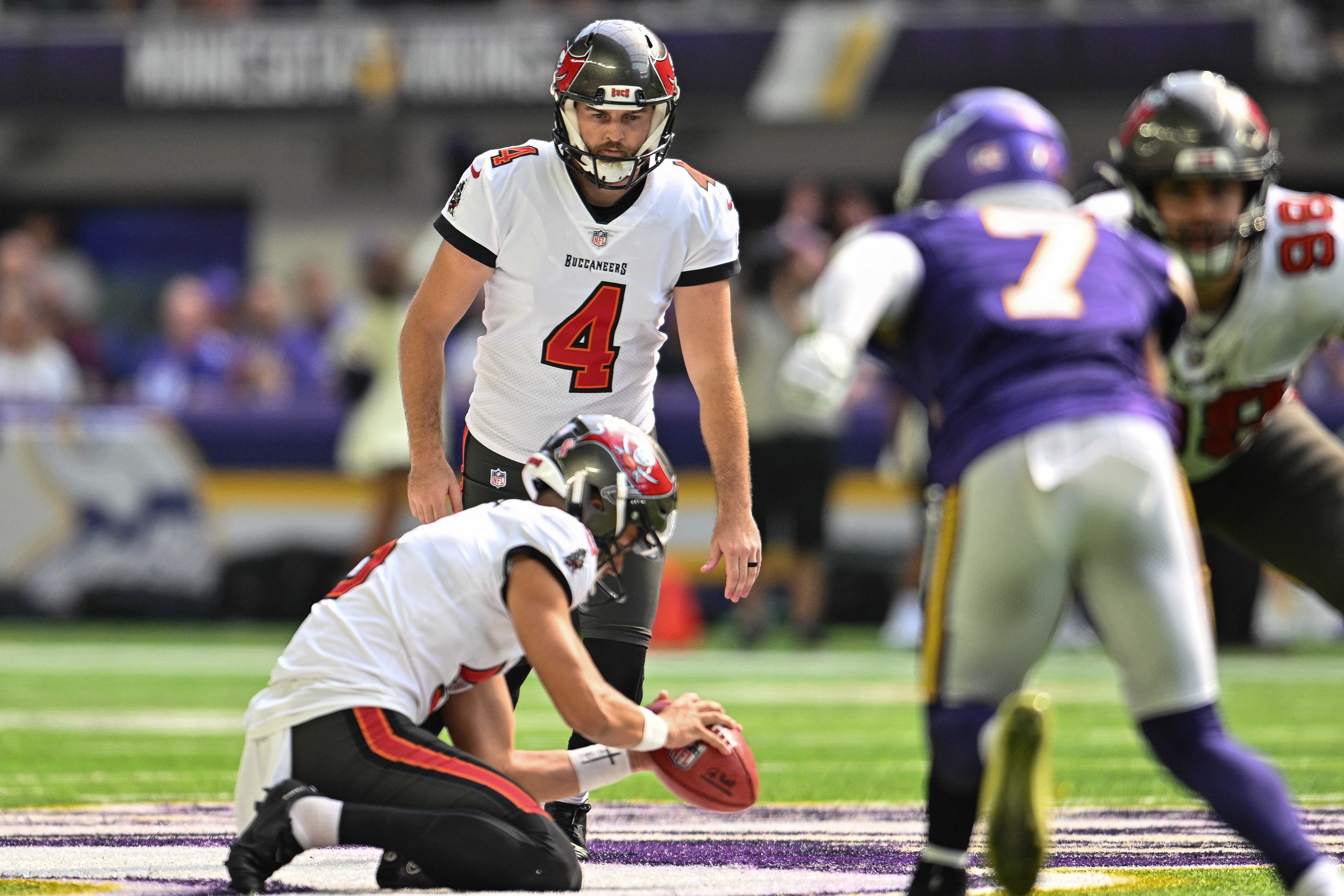 Sep 10, 2023; Minneapolis, Minnesota, USA; Tampa Bay Buccaneers place kicker Chase McLaughlin (4) kicks the game-winning field goal as placeholder Jake Camarda (5) holds the ball during the fourth quarter against the Minnesota Vikings at U.S. Bank Stadium. Mandatory Credit: Jeffrey Becker-USA TODAY Sports