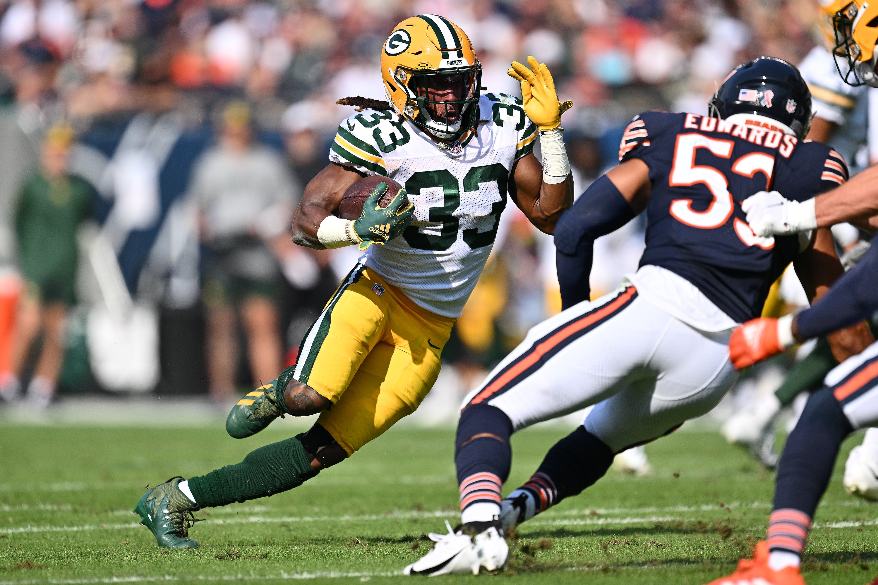 Sep 10, 2023; Chicago, Illinois, USA; Green Bay Packers running back Aaron Jones (33) runs for yardage in the first half against the Chicago Bears at Soldier Field. Mandatory Credit: Jamie Sabau-USA TODAY Sports