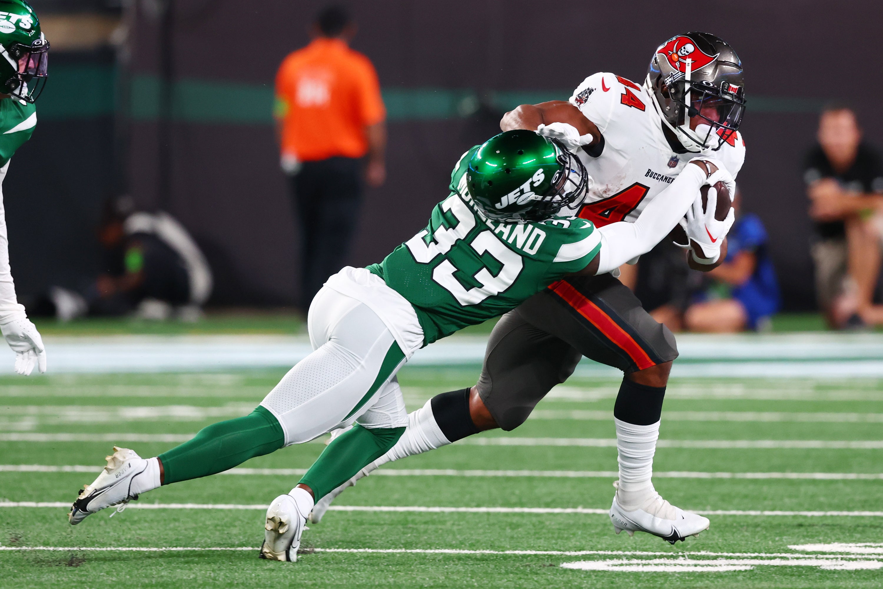 Aug 19, 2023; East Rutherford, New Jersey, USA; Tampa Bay Buccaneers running back Sean Tucker (44) runs with the ball while New York Jets cornerback Jimmy Moreland (33) attempts to tackle him during the first half at MetLife Stadium. Mandatory Credit: Ed Mulholland-USA TODAY Sports