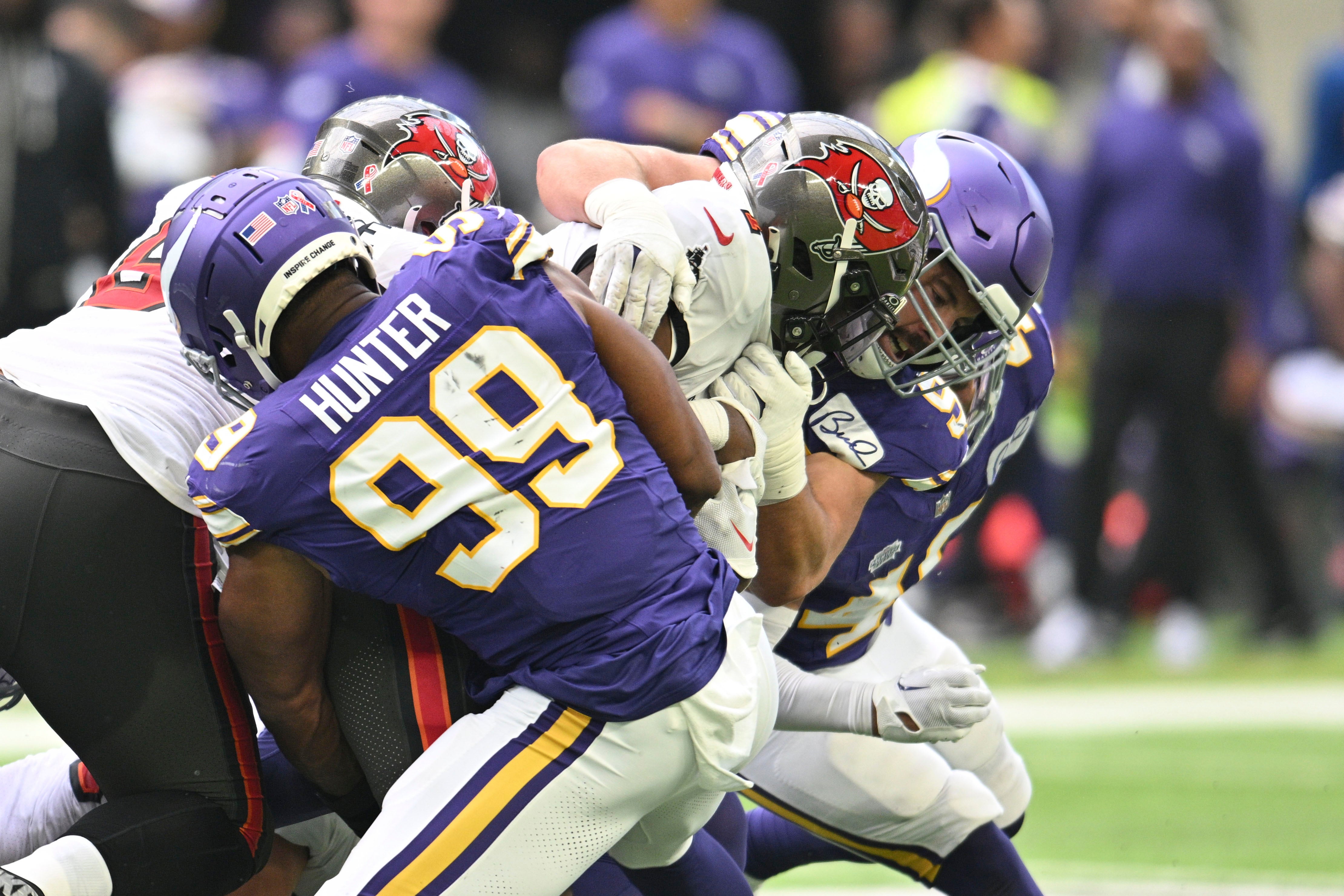 Sep 10, 2023; Minneapolis, Minnesota, USA; Tampa Bay Buccaneers running back Rachaad White (1) is tackled by Minnesota Vikings linebacker Danielle Hunter (99) and defensive end Dean Lowry (94) and linebacker Ivan Pace Jr. (40) as guard Luke Goedeke (67) attempts to block during the second quarter at U.S. Bank Stadium. Mandatory Credit: Jeffrey Becker-USA TODAY Sports