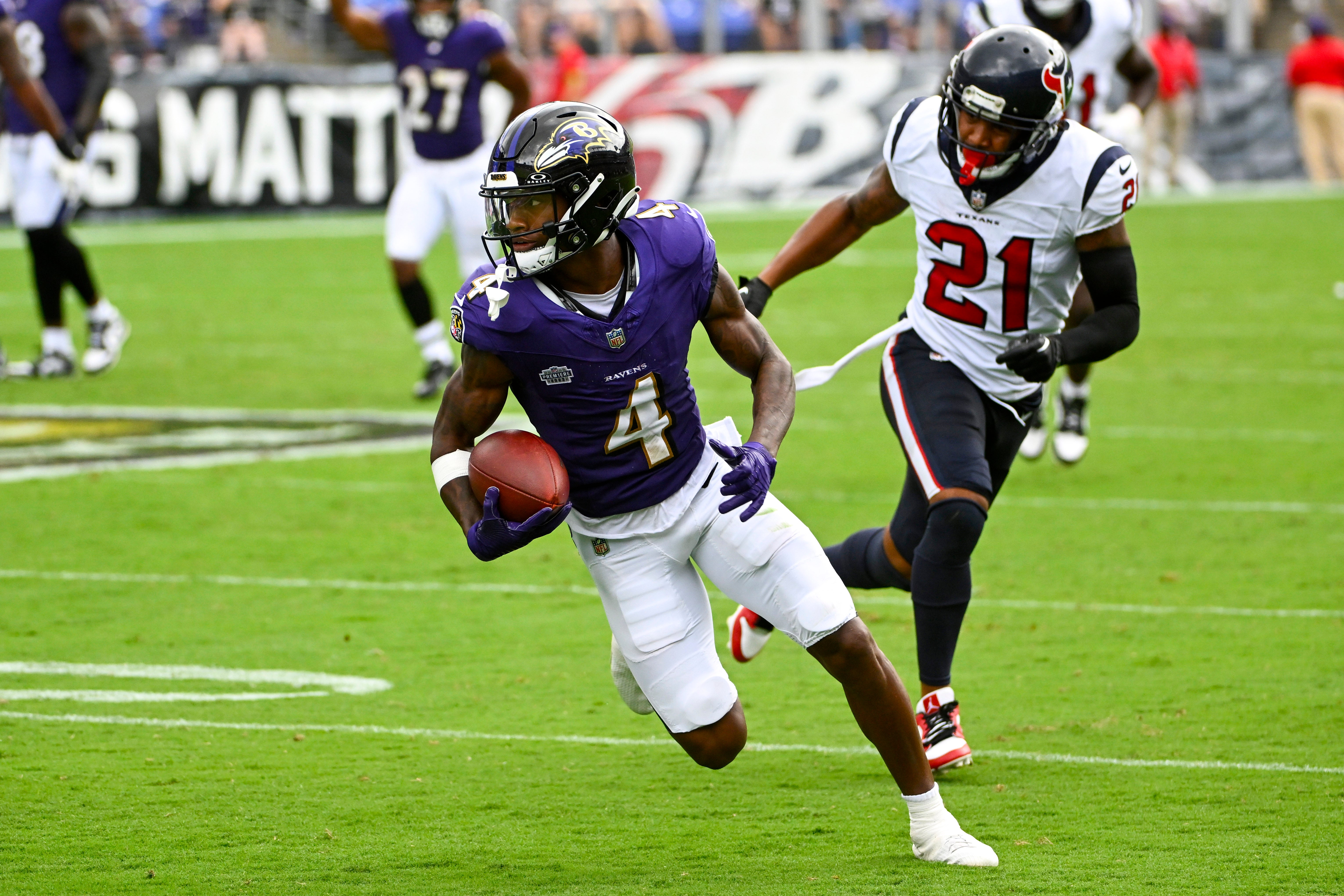 Sep 10, 2023; Baltimore, Maryland, USA; Baltimore Ravens wide receiver Zay Flowers (4) runs after a reception as Houston Texans cornerback Steven Nelson (21) chases during the second half at M&T Bank Stadium. Mandatory Credit: Brad Mills-USA TODAY Sports