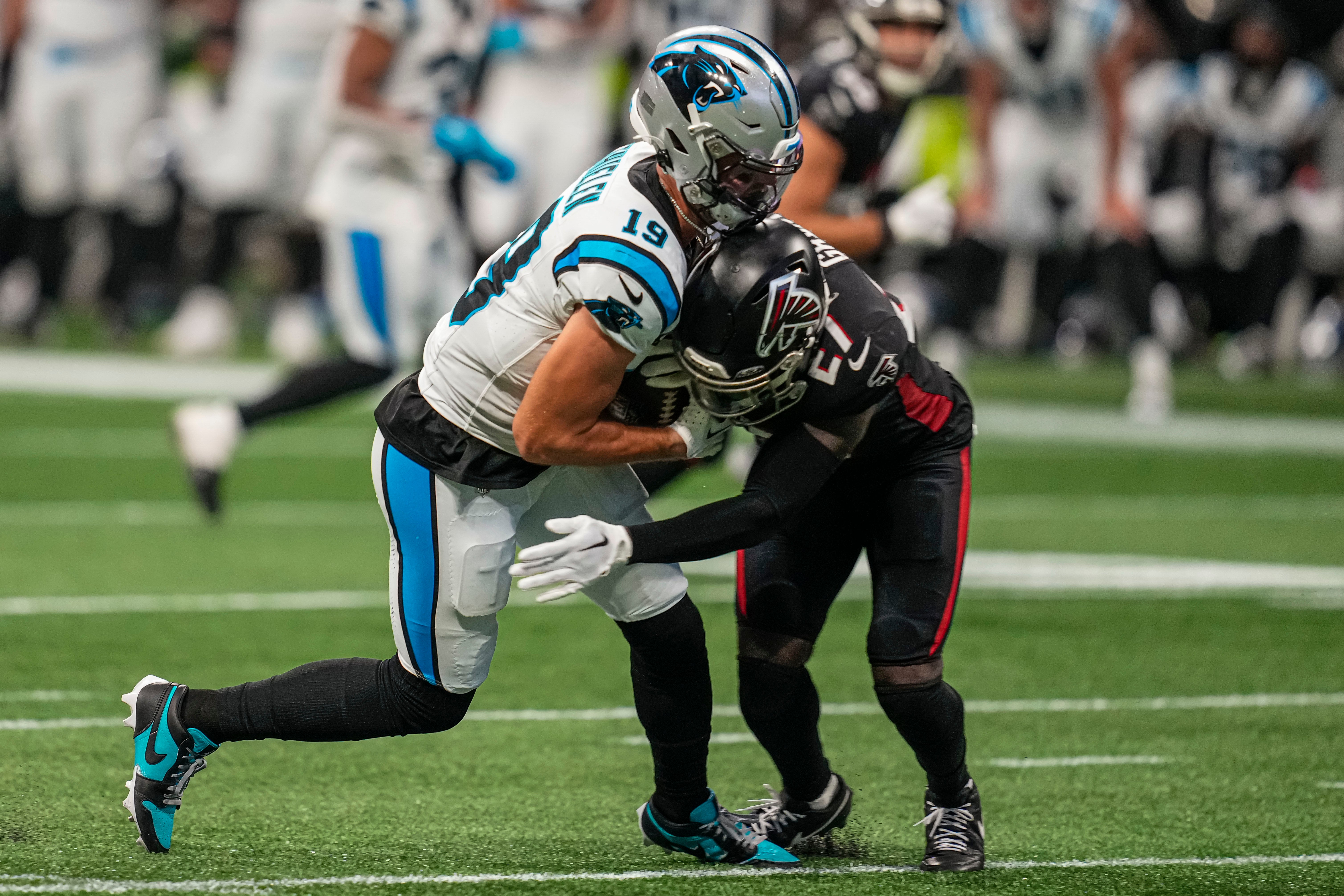 Sep 10, 2023; Atlanta, Georgia, USA; Carolina Panthers wide receiver Adam Thielen (19) is hit by Atlanta Falcons safety Richie Grant (27) after making a catch during the second half at Mercedes-Benz Stadium. Mandatory Credit: Dale Zanine-USA TODAY Sports