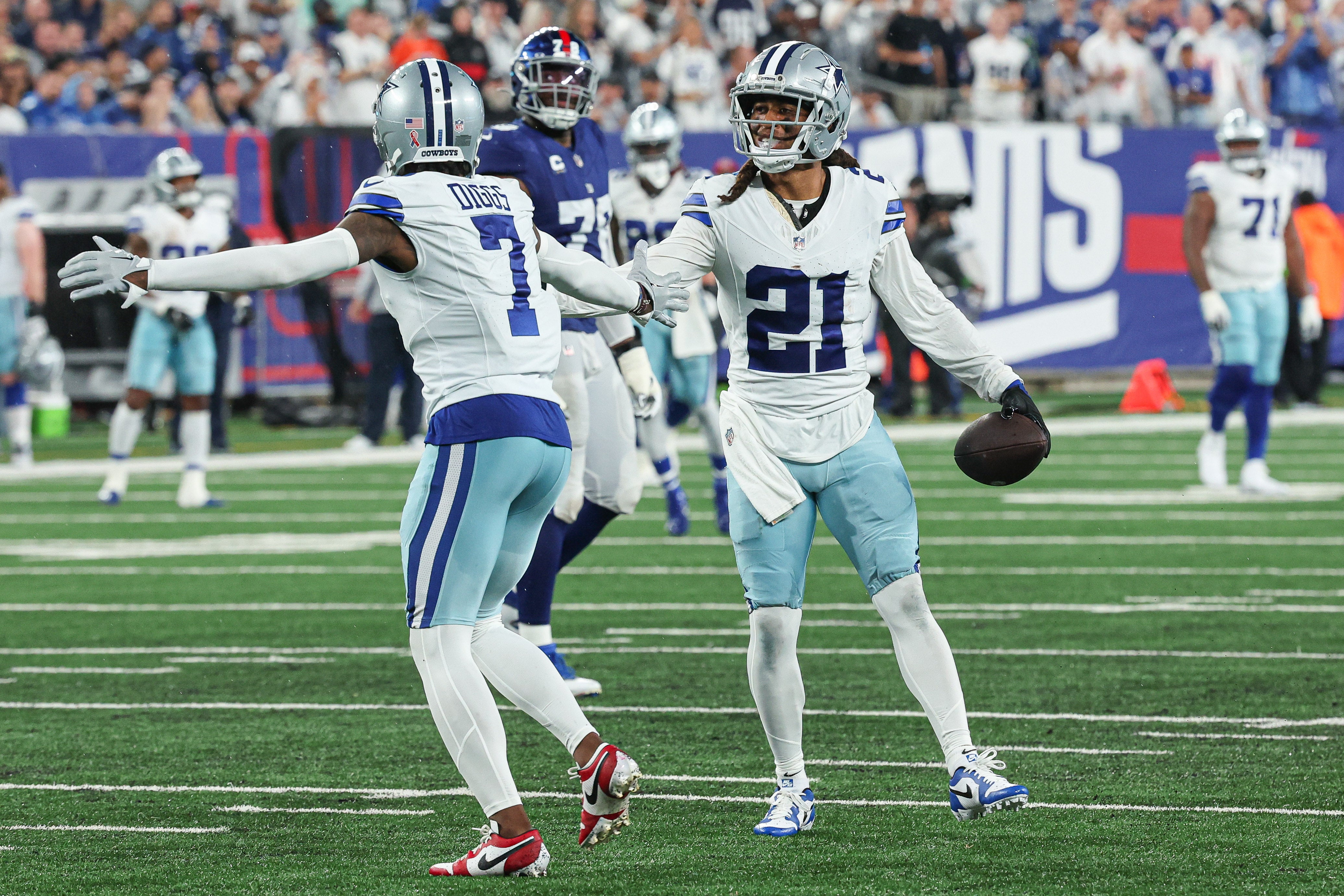 Sep 10, 2023; East Rutherford, New Jersey, USA; Dallas Cowboys cornerback Stephon Gilmore (21) celebrates his interception with cornerback Trevon Diggs (7) during the first half against the New York Giants at MetLife Stadium.