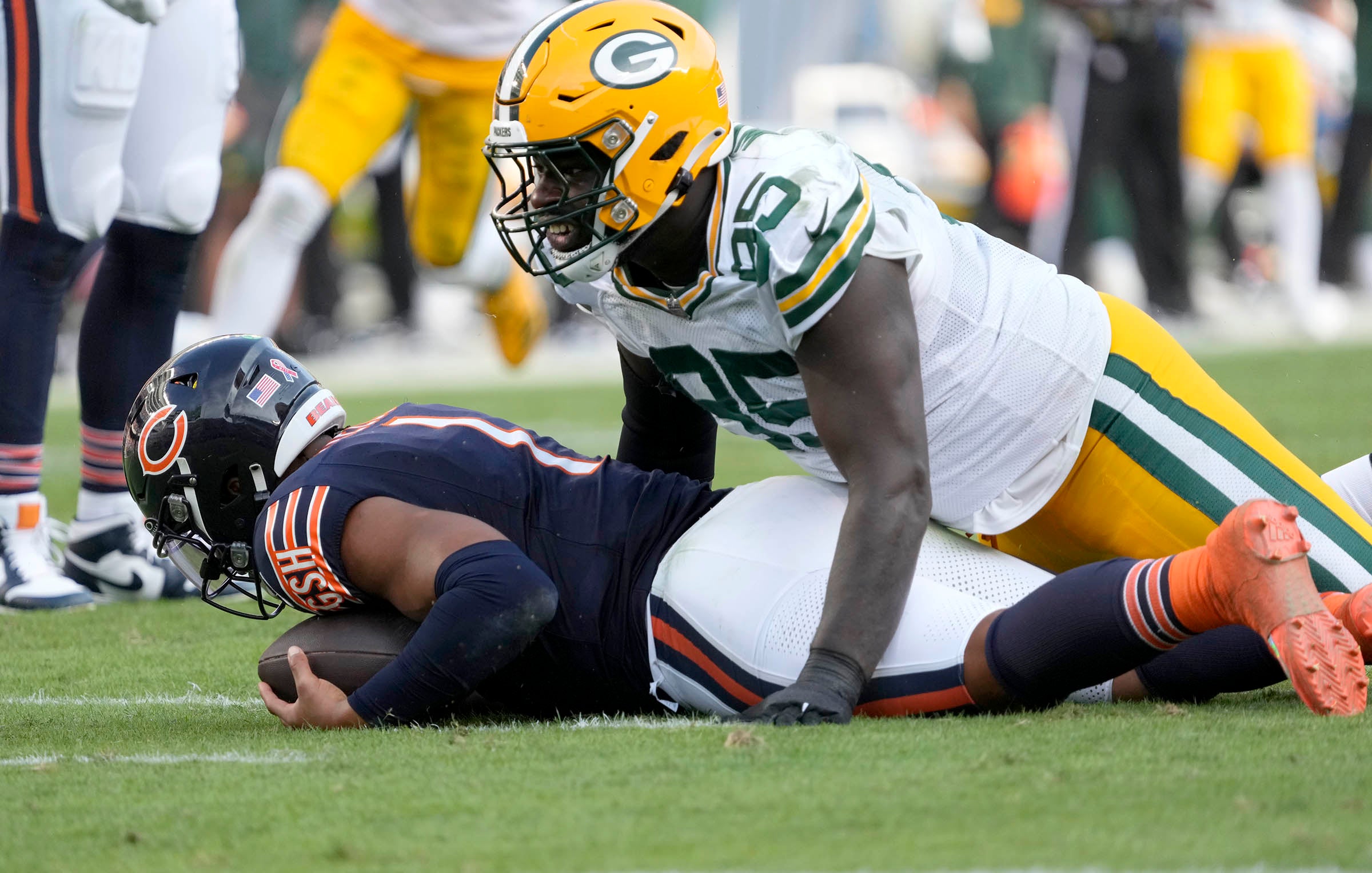 Sep 10, 2023; Chicago, Illinois, USA; Green Bay Packers defensive tackle Colby Wooden (96) sacks Chicago Bears quarterback Justin Fields (1) during the second half of their game at Soldier Field. Mandatory Credit: Mike De Sisti-USA TODAY Sports