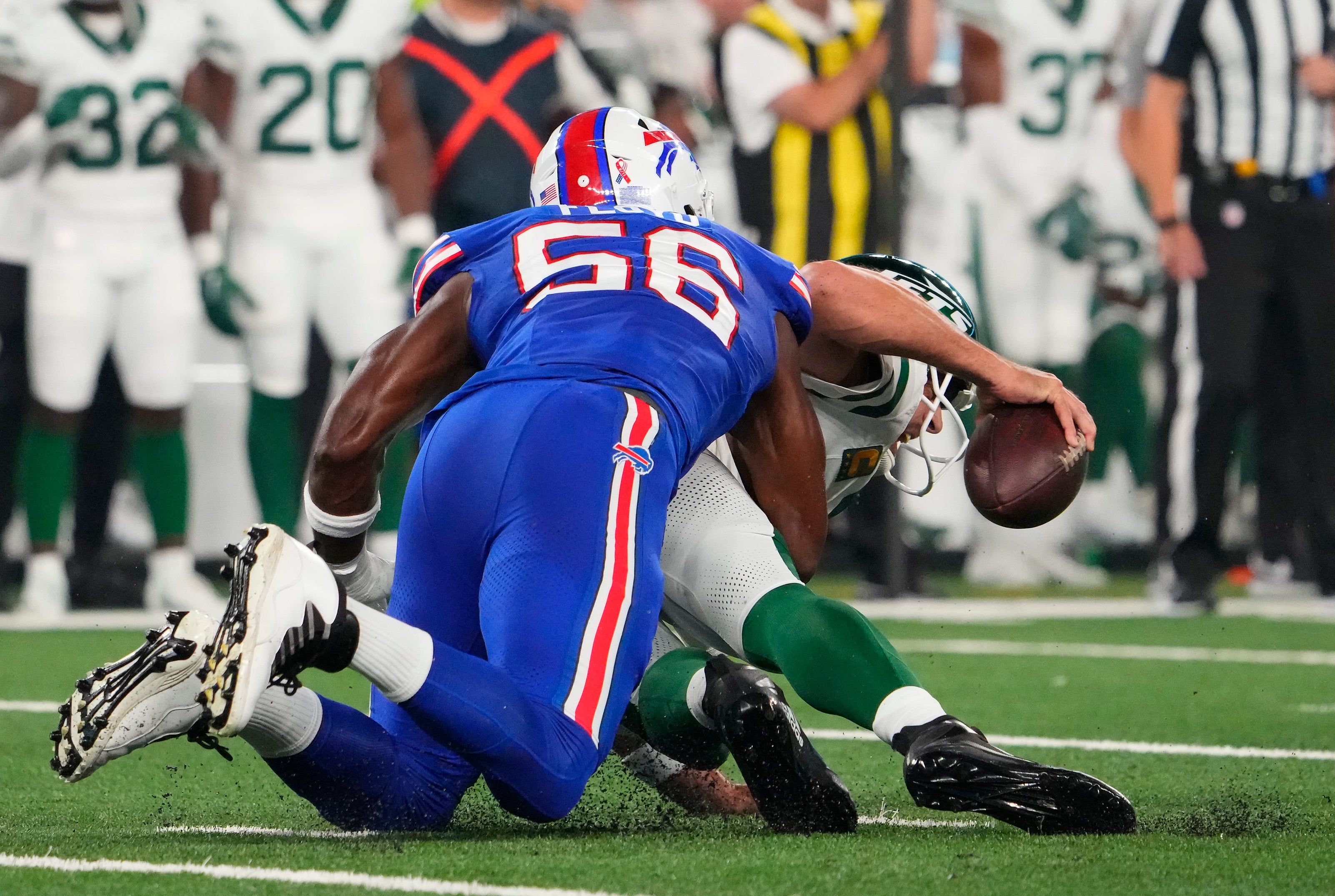 Buffalo Bills defensive end Leonard Floyd (56) sacks New York Jets quarterback Aaron Rodgers (8) in the fourth play from scrimmage at MetLife Stadium. Rogers left the game with an injury and did not return. Mandatory Credit: Robert Deutsch-USA TODAY Sports