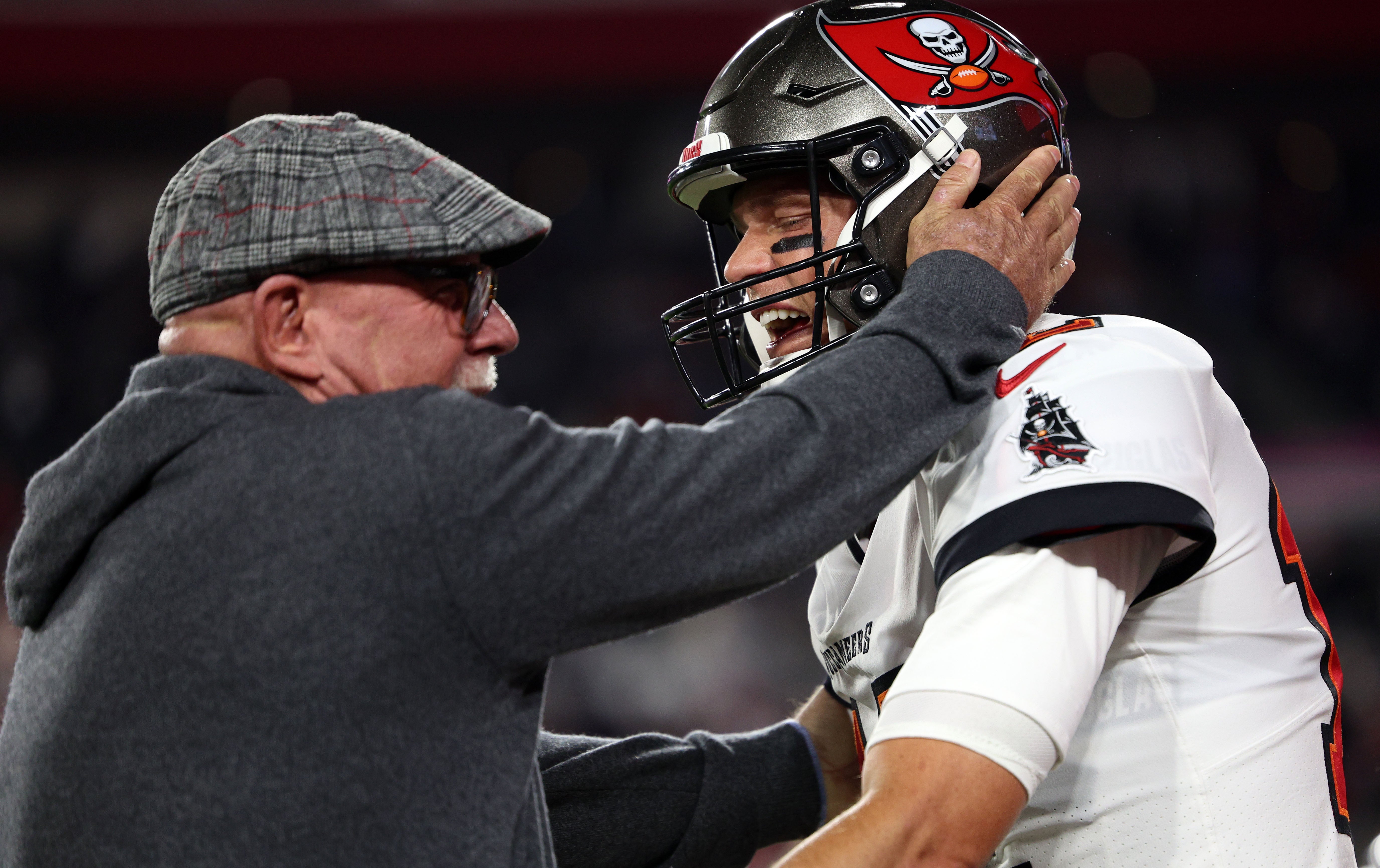 Jan 16, 2023; Tampa, Florida, USA; Tampa Bay Buccaneers senior football consultant Bruce Arians reacts with quarterback Tom Brady (12) against the Dallas Cowboys during a wild card game at Raymond James Stadium. Mandatory Credit: Nathan Ray Seebeck-USA TODAY Sports