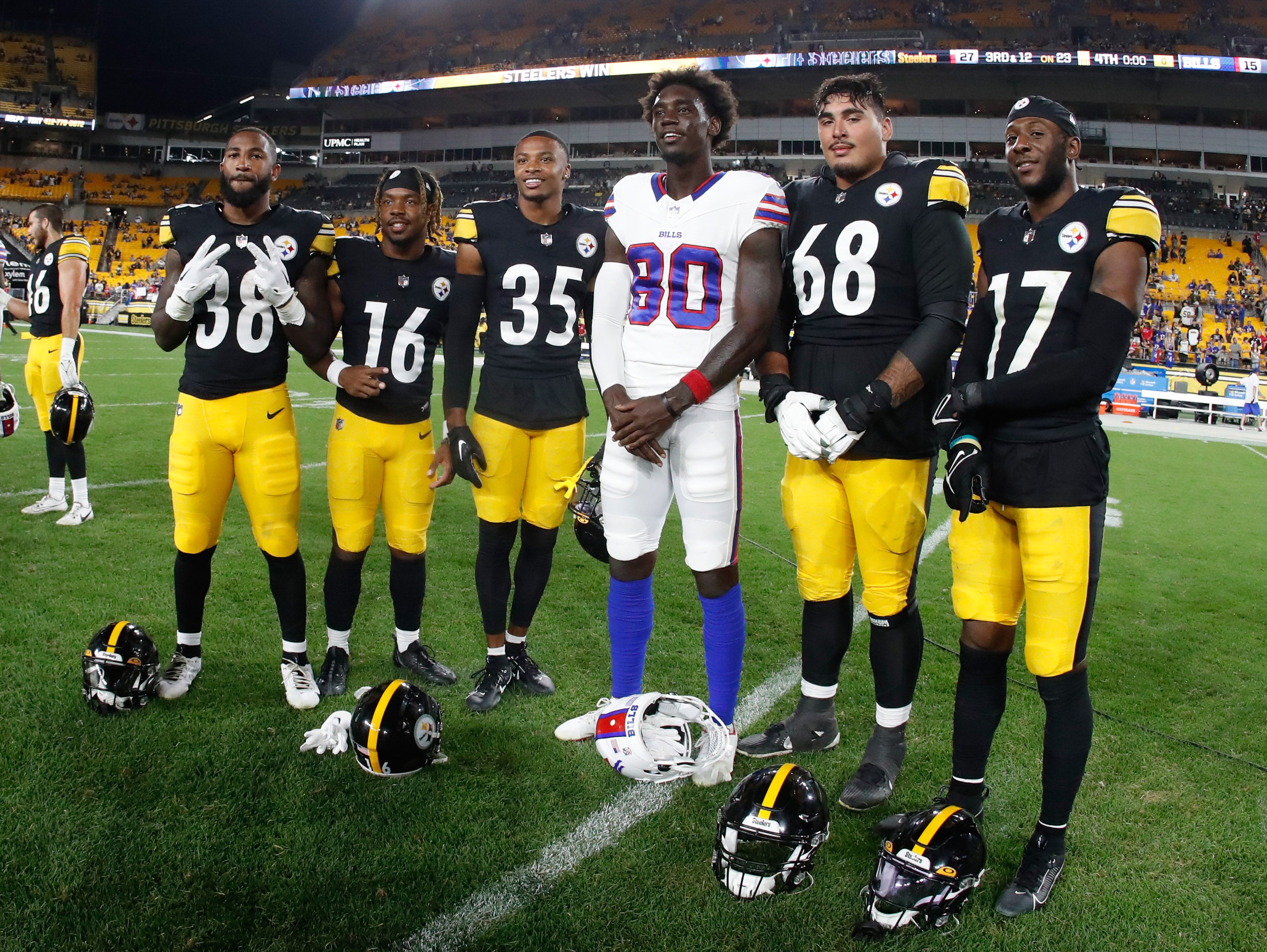 Aug 19, 2023; Pittsburgh, Pennsylvania, USA; San Diego State University alumni Pittsburgh Steelers Greg Bell (38) and Jordan Byrd (16) and Luq Barcoo (35) and William Dunkle (68) and Trenton Thompson (17) along with Buffalo Bills wide receiver Tyrell Shavers (80) pose for a photo after the game at Acrisure Stadium. Mandatory Credit: Charles LeClaire-USA TODAY Sports  