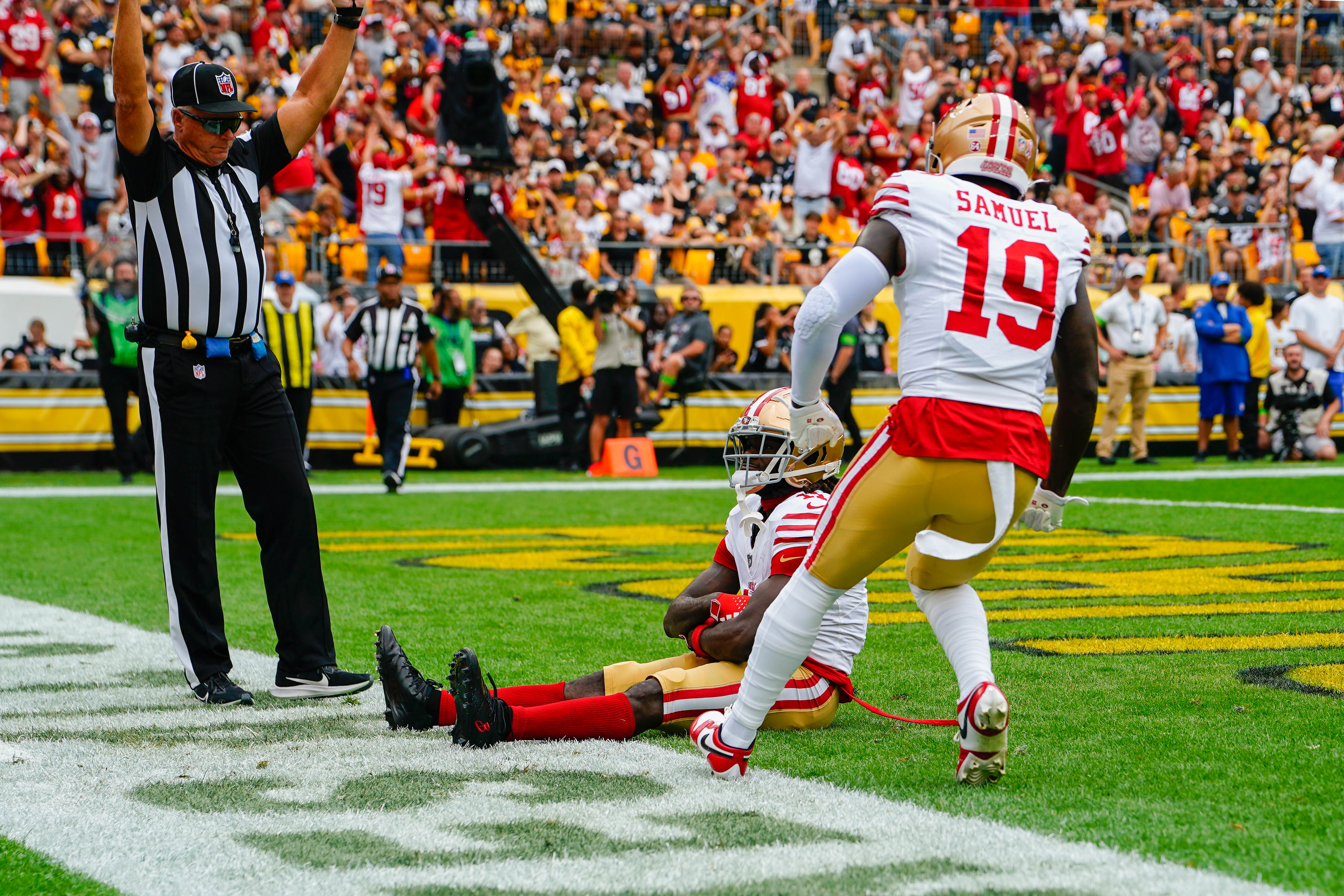 Sep 10, 2023; Pittsburgh, Pennsylvania, USA; San Francisco 49ers wide receiver Brandon Aiyuk (11) sits with the ball after scoring a touchdown with San Francisco 49ers wide receiver Deebo Samuel (19) reacting during the first half at Acrisure Stadium. Mandatory Credit: Gregory Fisher-USA TODAY Sports