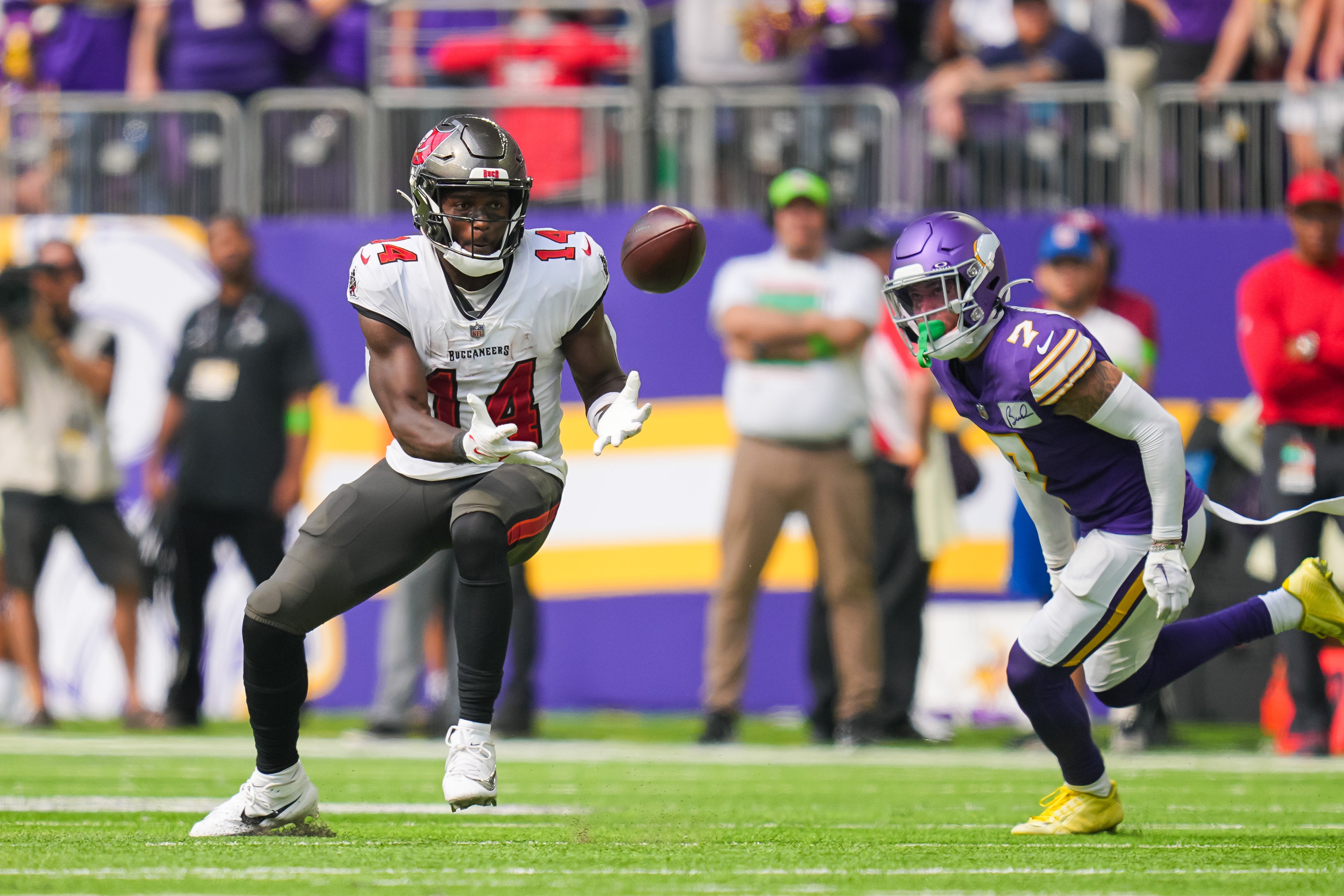 Sep 10, 2023; Minneapolis, Minnesota, USA; Tampa Bay Buccaneers wide receiver Chris Godwin (14) catches a pass against the Minnesota Vikings cornerback Byron Murphy Jr. (7) in the fourth quarter at U.S. Bank Stadium. Mandatory Credit: Brad Rempel-USA TODAY Sports