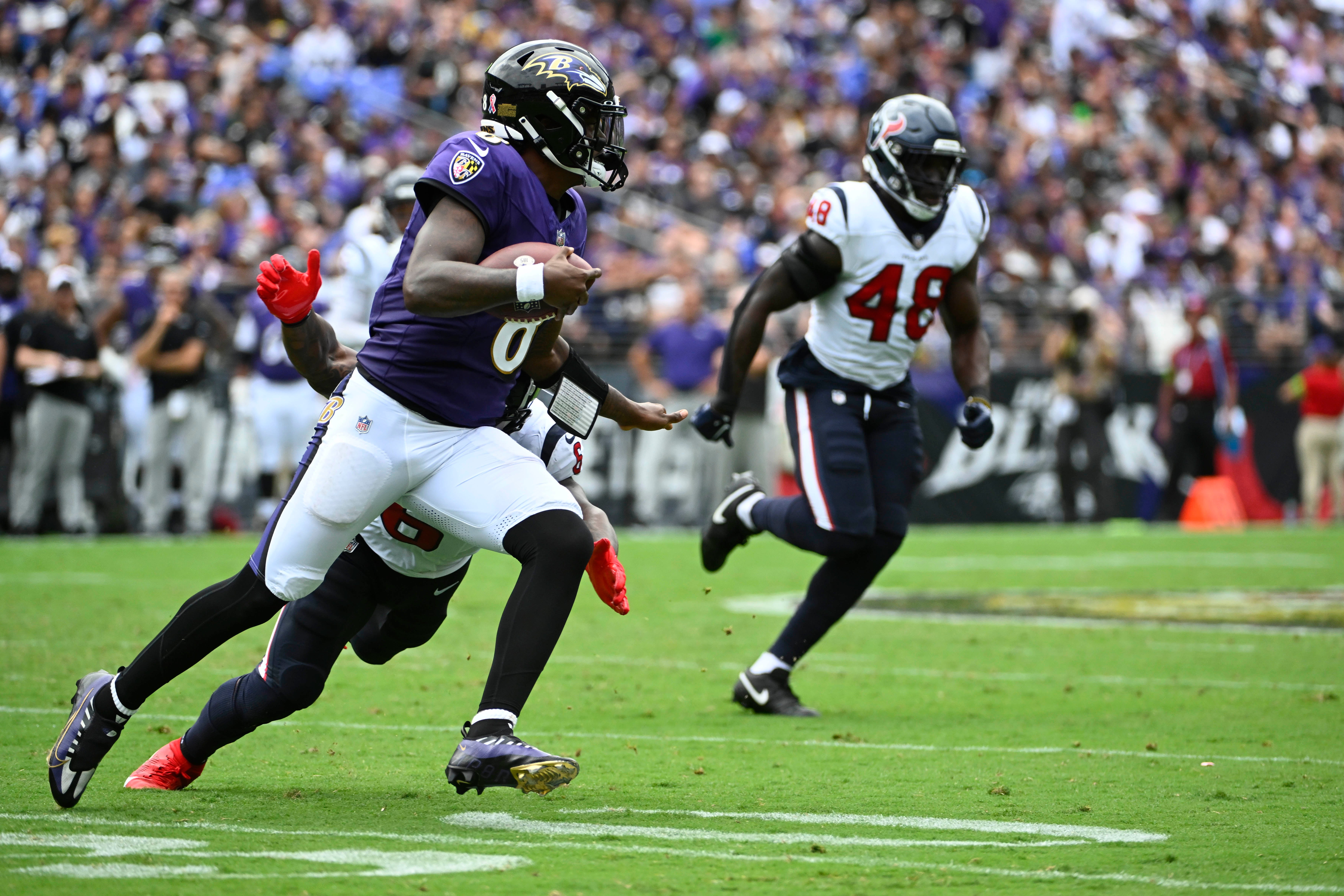Sep 10, 2023; Baltimore, Maryland, USA; Baltimore Ravens quarterback Lamar Jackson (8) scrambles against the Houston Texans during the first half at M&T Bank Stadium. Mandatory Credit: Brad Mills-USA TODAY Sports