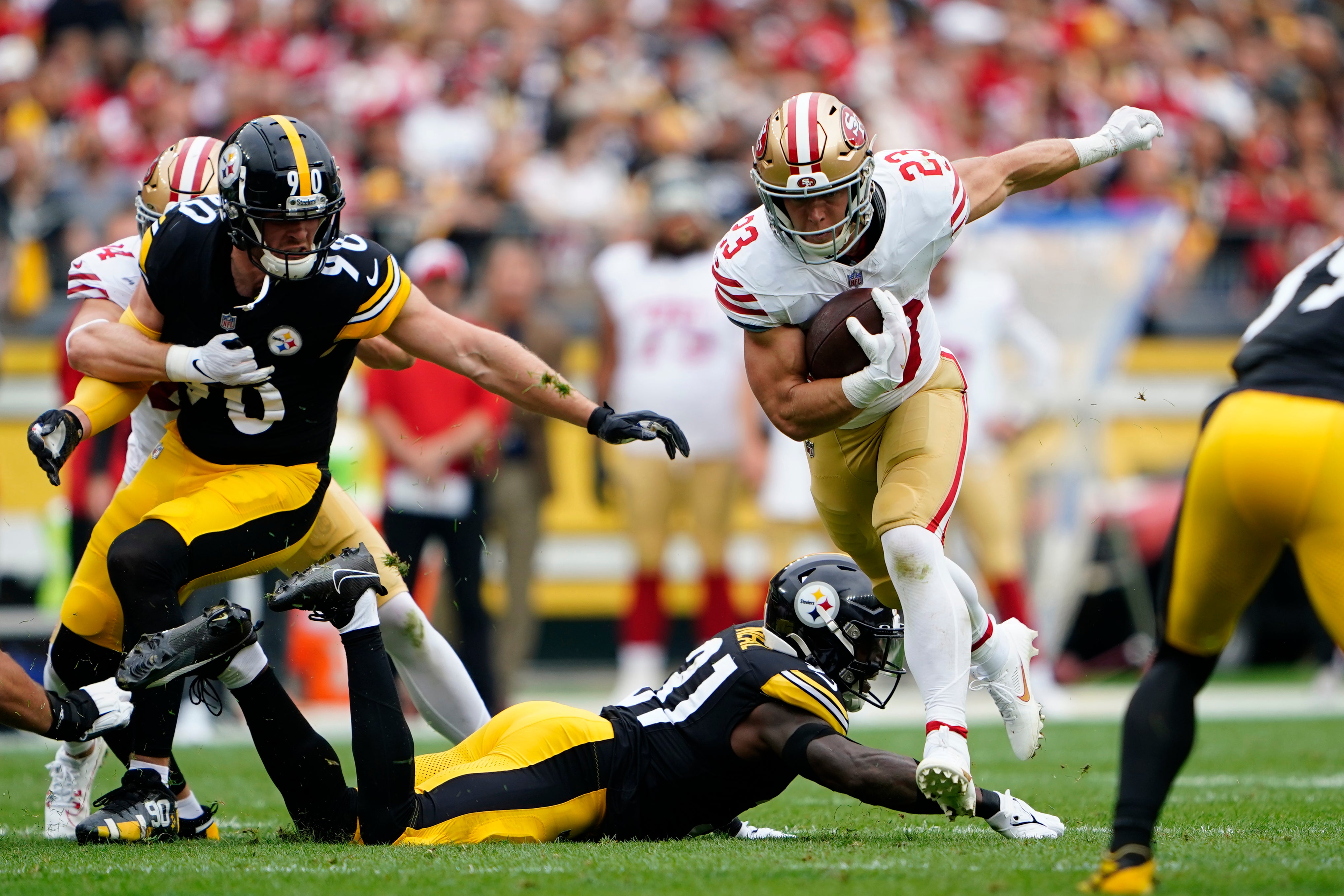 Sep 10, 2023; Pittsburgh, Pennsylvania, USA; San Francisco 49ers running back Christian McCaffrey (23) leaps over Pittsburgh Steelers safety Keanu Neal (31) while running with the ball during the first half at Acrisure Stadium. Mandatory Credit: Gregory Fisher-USA TODAY Sports