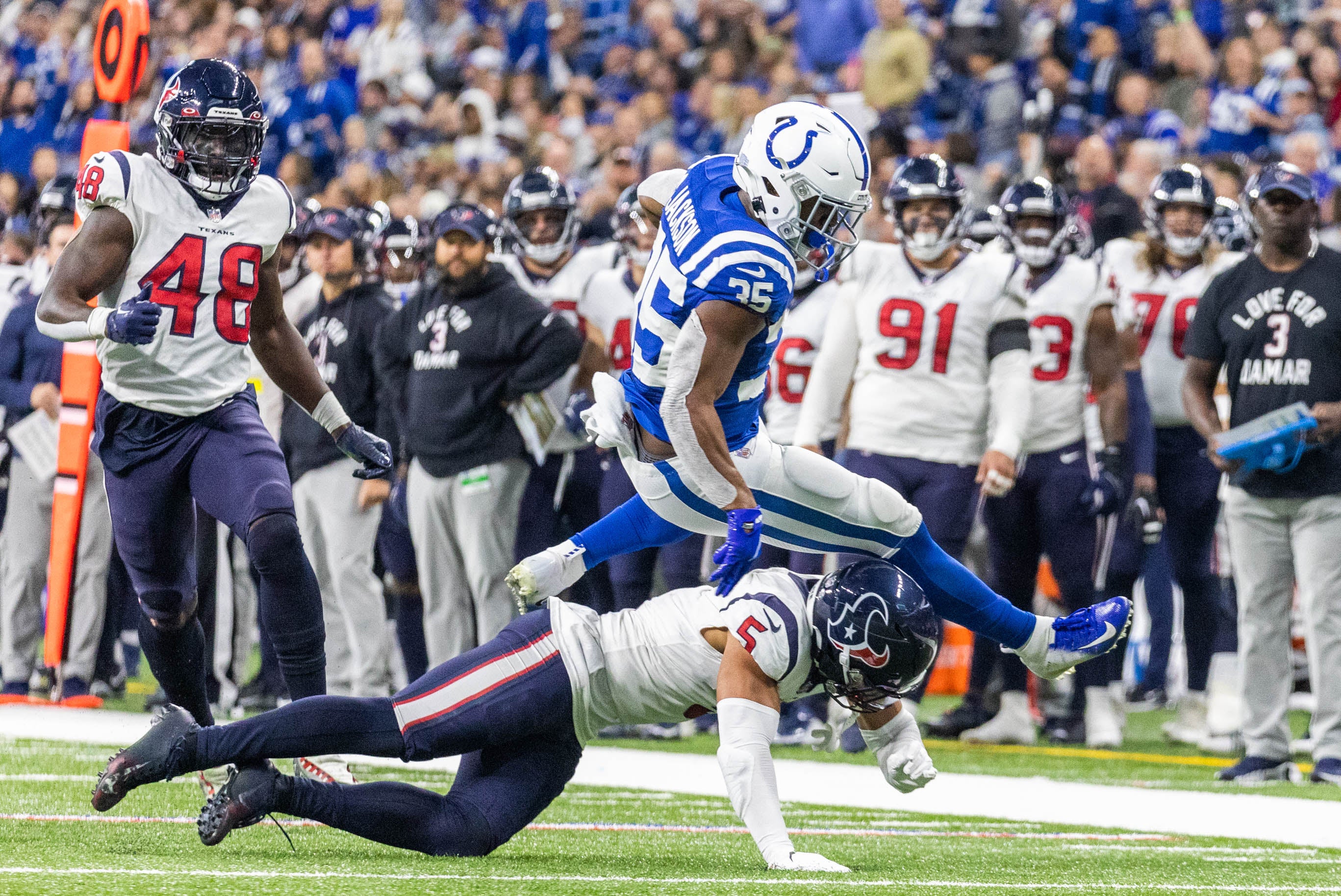Jan 8, 2023; Indianapolis, Indiana, USA; Indianapolis Colts running back Deon Jackson (35) runs the ball while Houston Texans safety Jalen Pitre (5) defends in the first half at Lucas Oil Stadium.