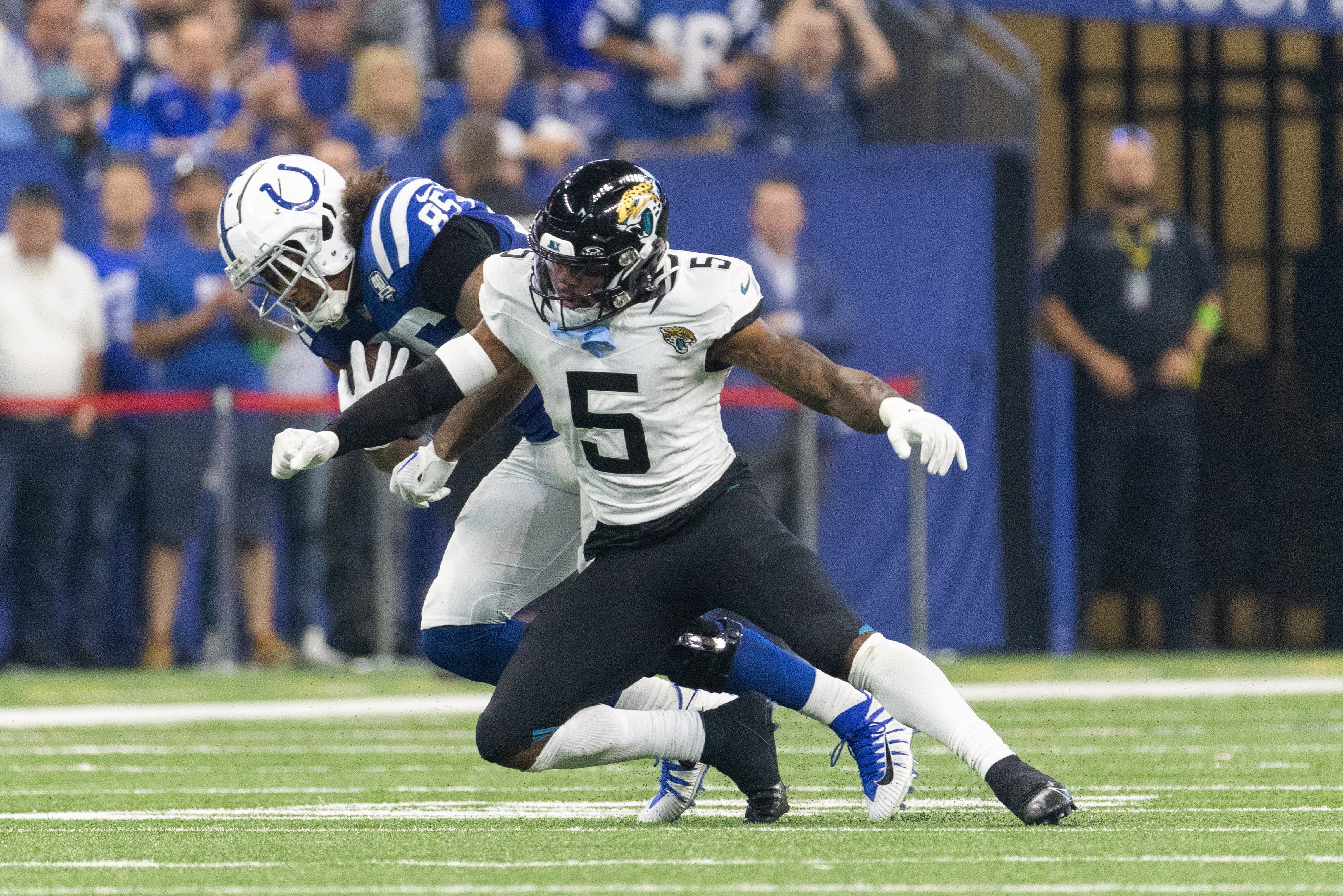 Sep 10, 2023; Indianapolis, Indiana, USA; Indianapolis Colts tight end Drew Ogletree (85) is tackled by Jacksonville Jaguars safety Andre Cisco (5) in the second quarter at Lucas Oil Stadium.