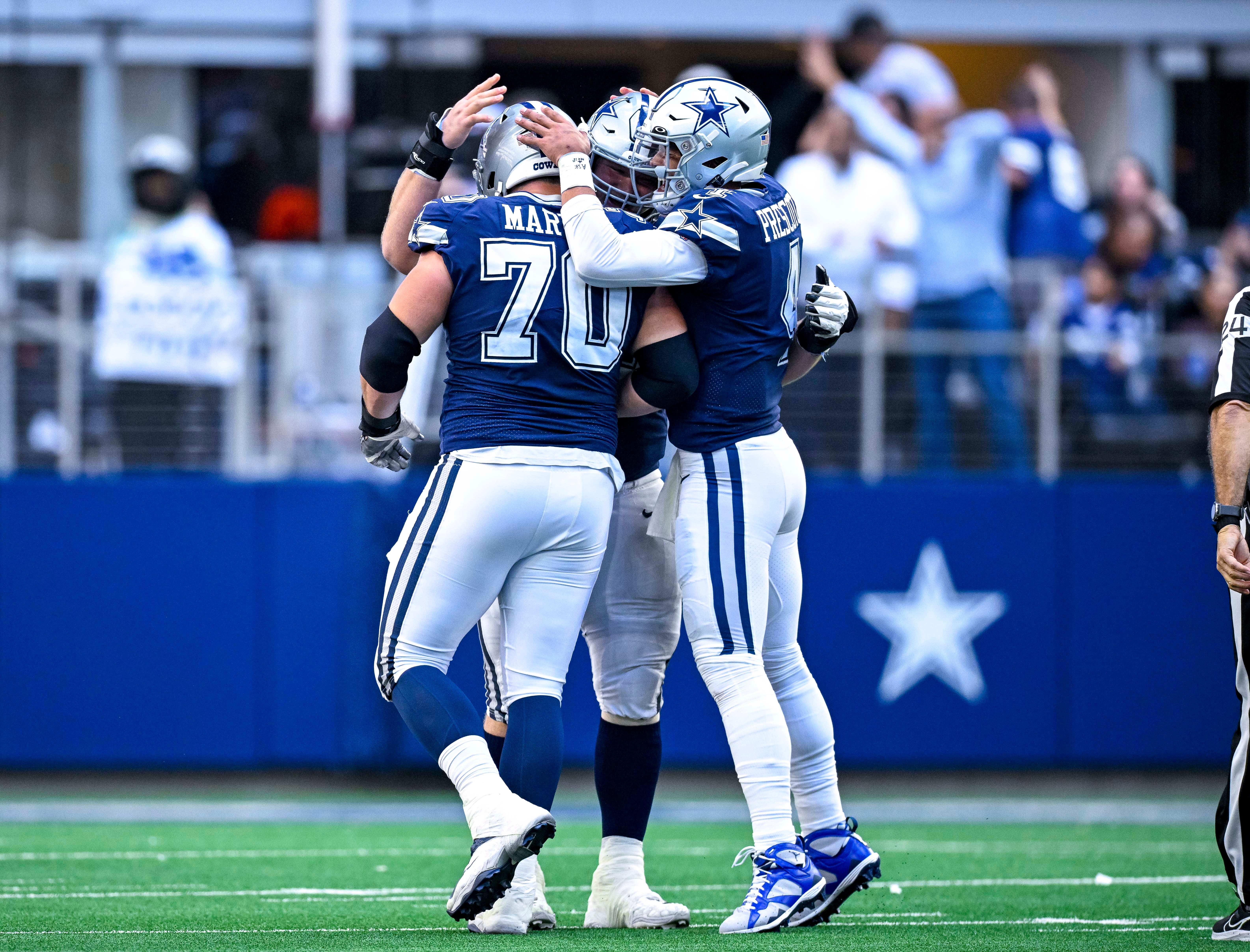 Dallas Cowboys quarterback Dak Prescott (4) and guard Zack Martin (70) celebrates a touchdown scored by running back Tony Pollard (not pictured) during the second half against the Chicago Bears at AT&T Stadium. Mandatory Credit: Jerome Miron-USA TODAY Sports  