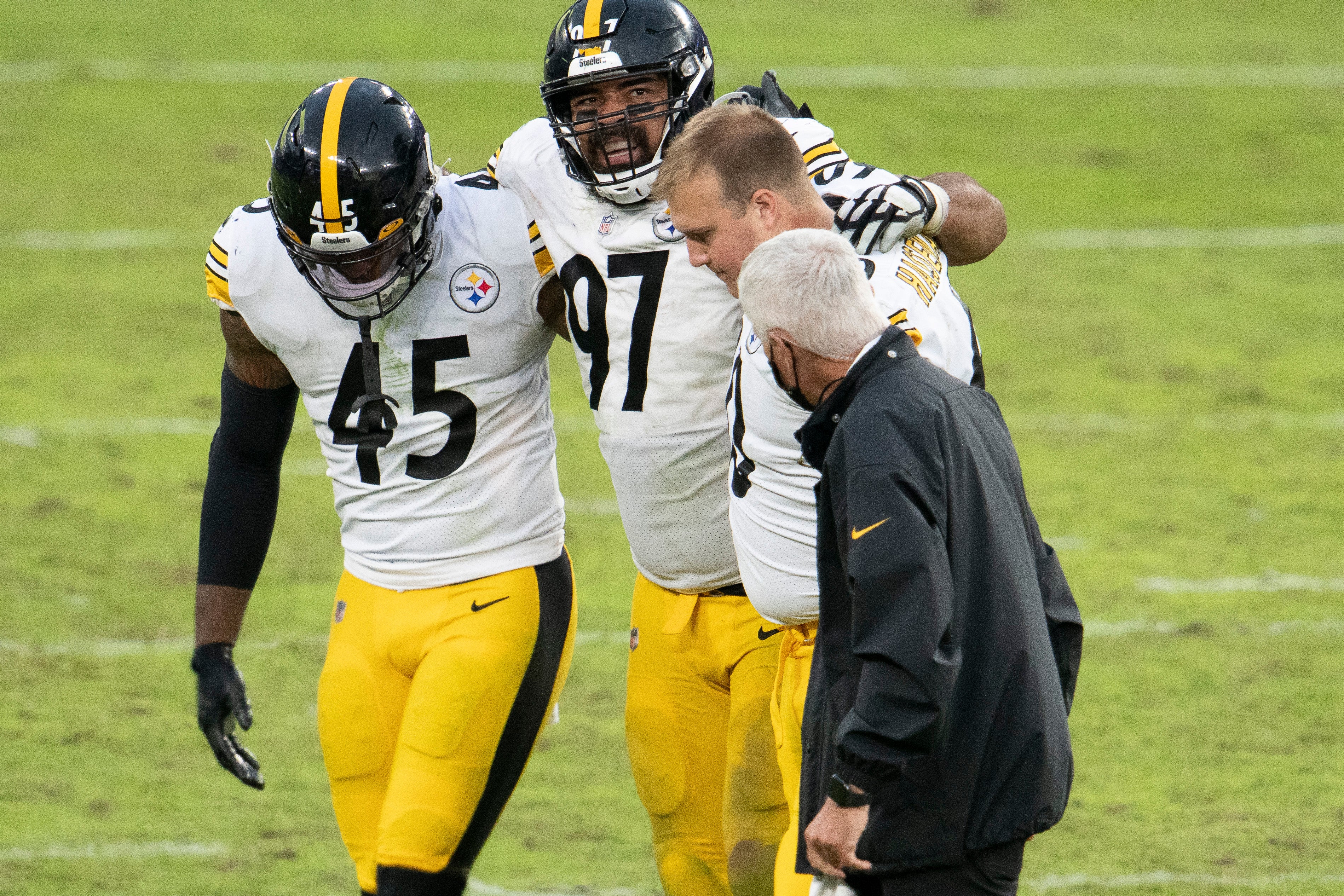 Nov 1, 2020; Baltimore, Maryland, USA; Pittsburgh Steelers defensive end Cameron Heyward (97) is helped off the field by *Pittsburgh Steelers linebacker John Houston (45) outside linebacker T.J. Watt (90) during the fourth quarter against the Baltimore Ravens at M&T Bank Stadium. Mandatory Credit: Tommy Gilligan-USA TODAY Sports