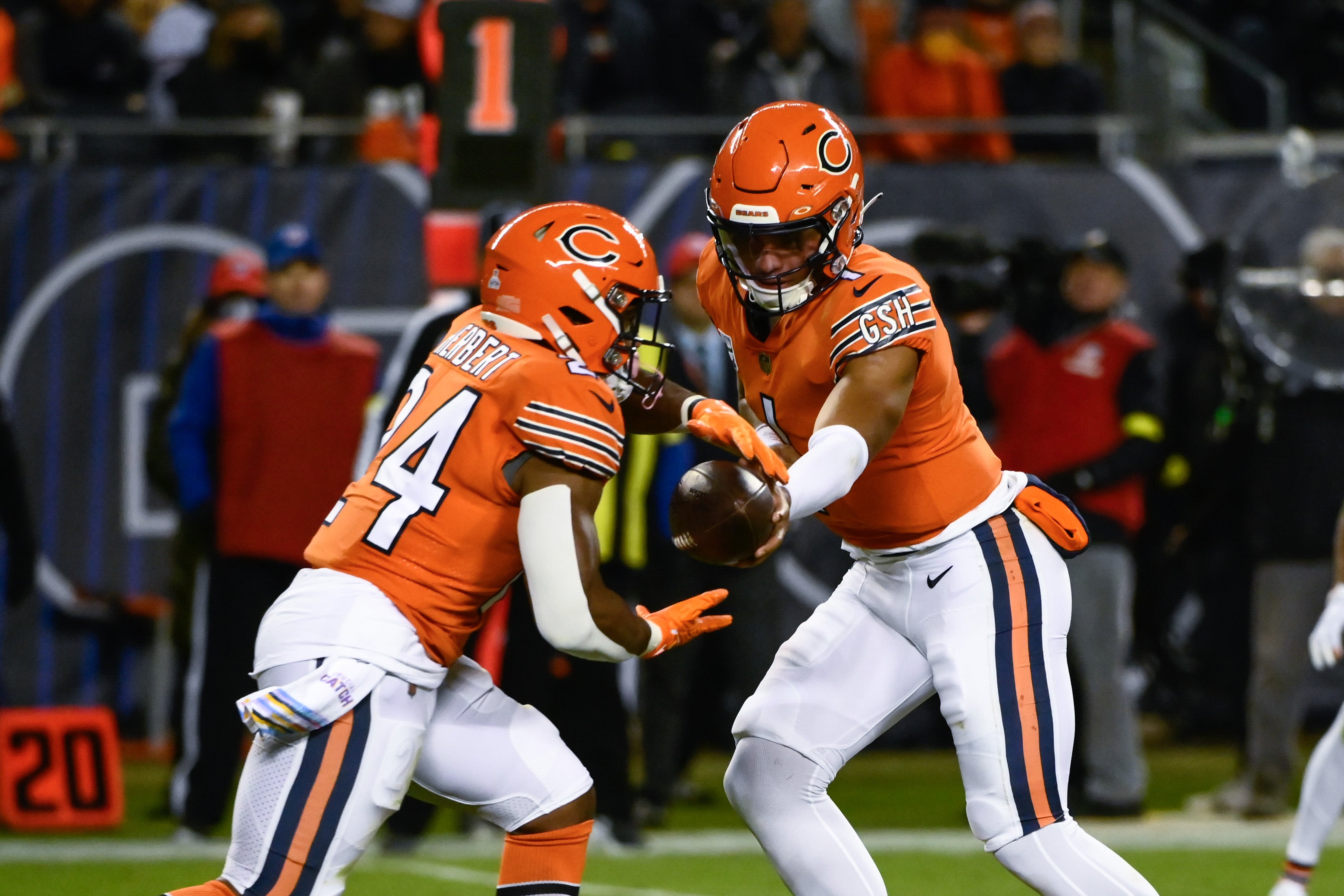 Oct 13, 2022; Chicago, Illinois, USA; Chicago Bears quarterback Justin Fields (1) hands off the ball to Chicago Bears running back Khalil Herbert (24) against the Washington Commanders during the first half at Soldier Field. Mandatory Credit: Matt Marton-USA TODAY Sports