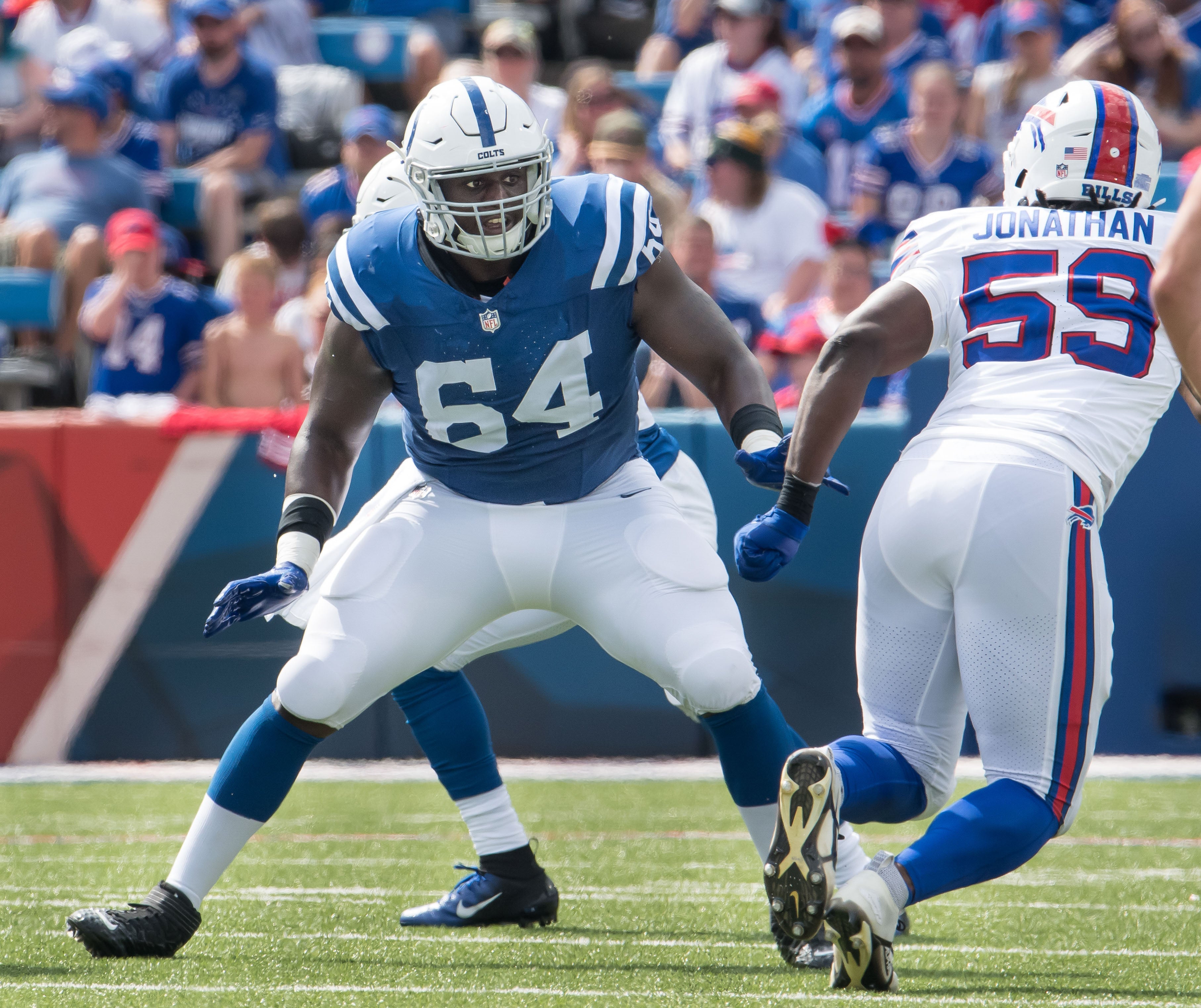 Aug 12, 2023; Orchard Park, New York, USA; Indianapolis Colts guard Arlington Hambright (64) prepares to block Buffalo Bills defensive end Kingsley Jonathan (59) in the fourth quarter of a pre-season game at Highmark Stadium.