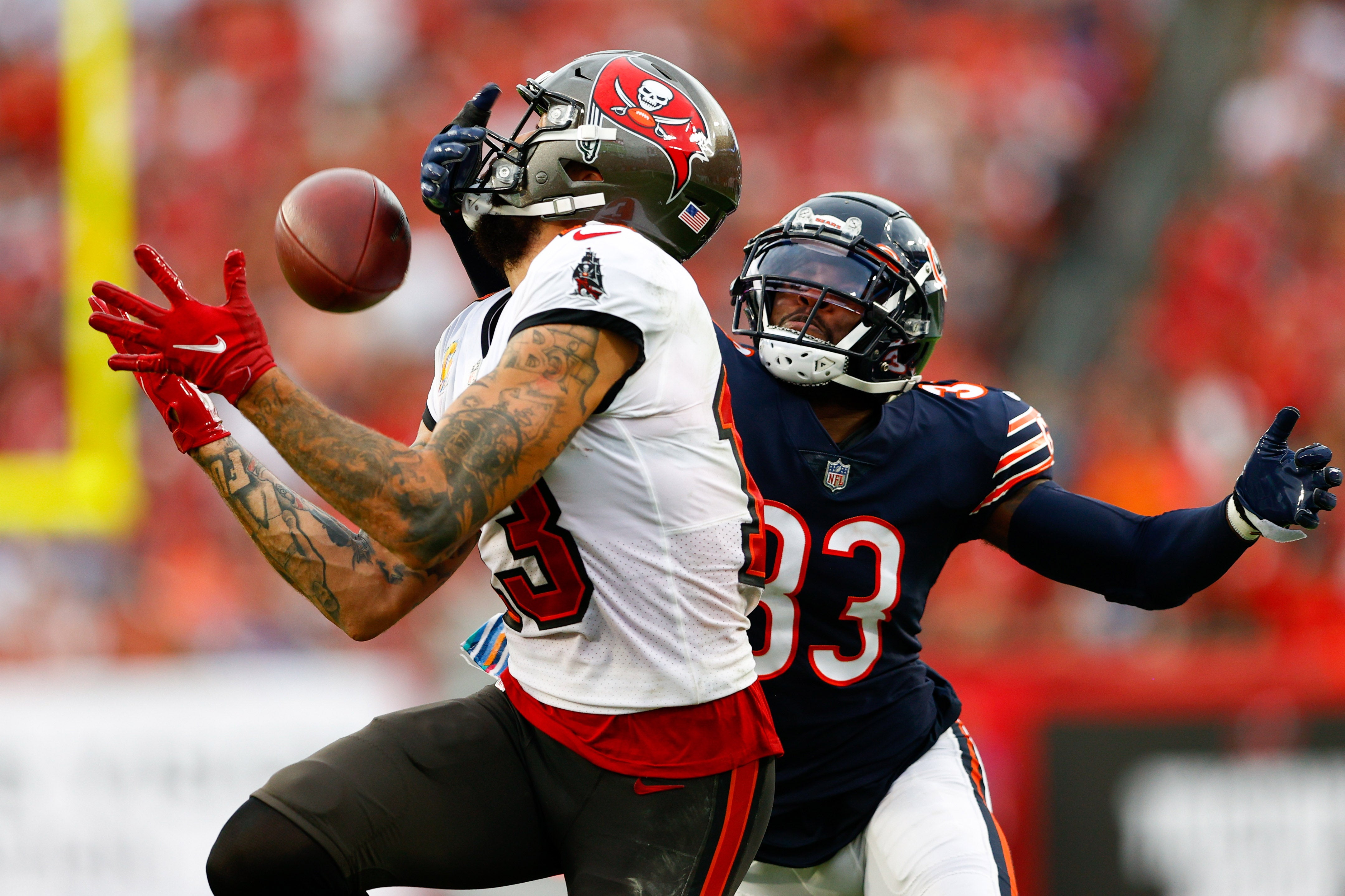 Oct 24, 2021; Tampa, Florida, USA; Tampa Bay Buccaneers wide receiver Mike Evans (13) catches a pass in the first half while defended by Chicago Bears cornerback Jaylon Johnson (33) at Raymond James Stadium. Mandatory Credit: Nathan Ray Seebeck-USA TODAY Sports  