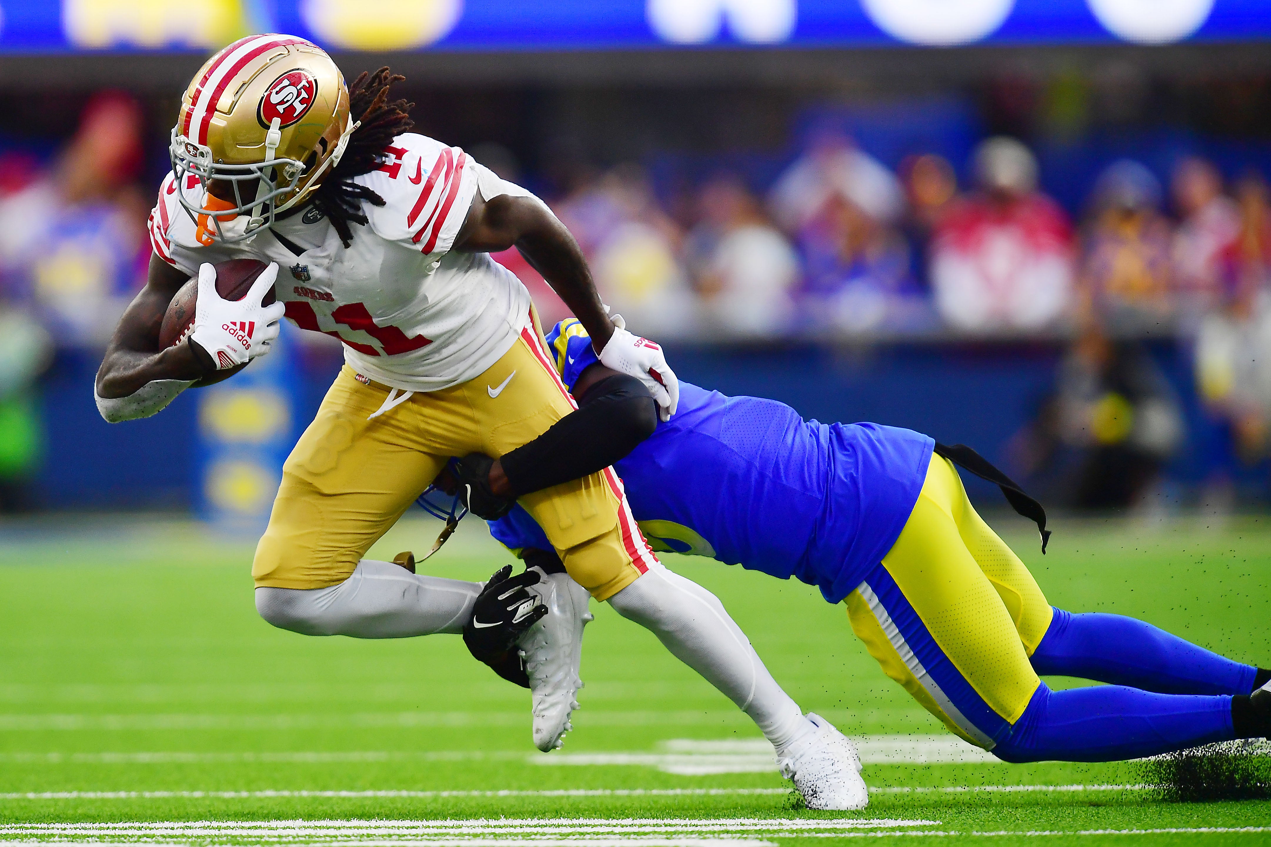 Oct 30, 2022; Inglewood, California, USA; San Francisco 49ers wide receiver Brandon Aiyuk (11) runs the ball against the Los Angeles Rams during the second half at SoFi Stadium. Mandatory Credit: Gary A. Vasquez-USA TODAY Sports