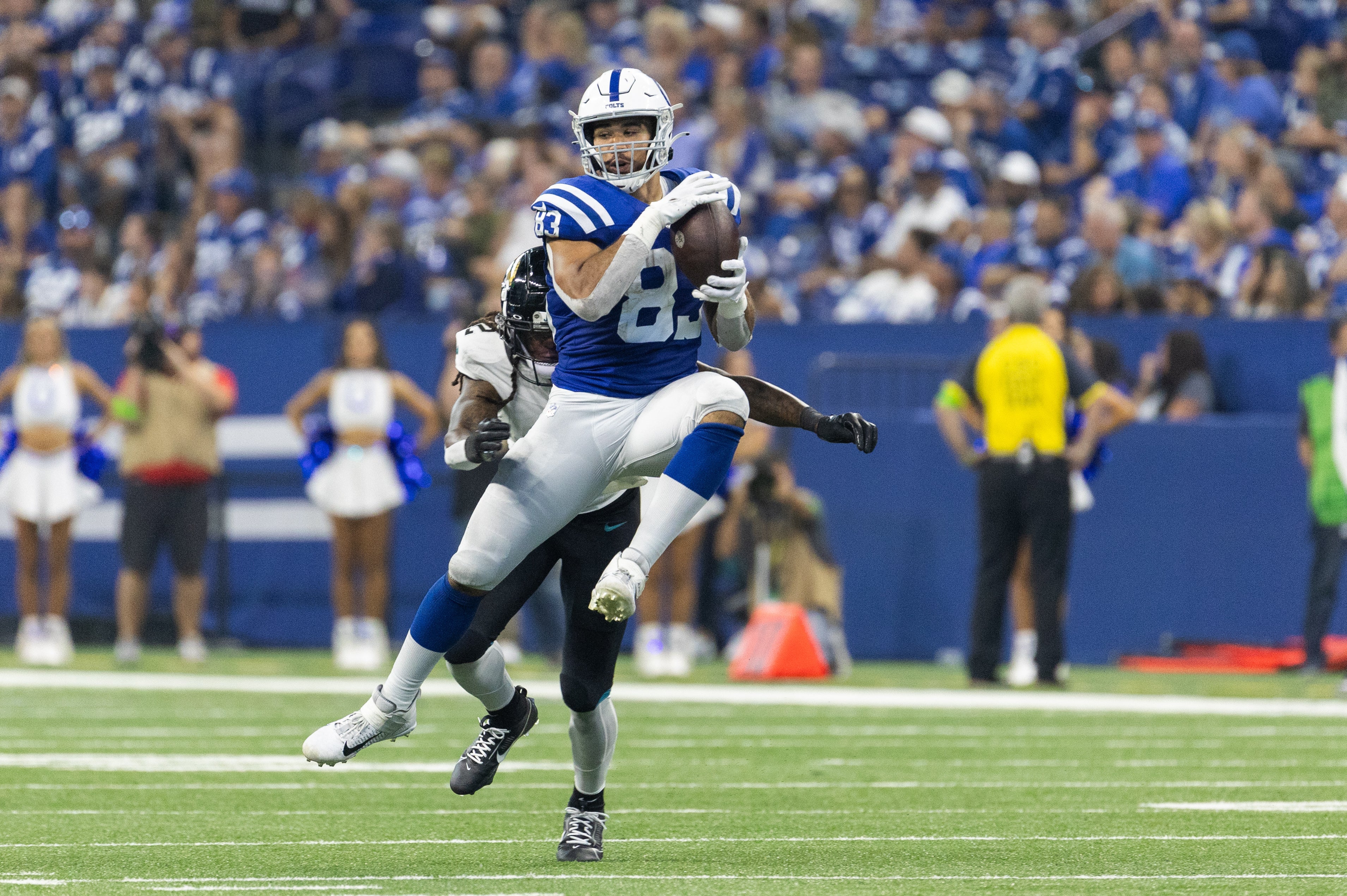 Sep 10, 2023; Indianapolis, Indiana, USA; Indianapolis Colts tight end Kylen Granson (83) catches the ball while Jacksonville Jaguars safety Rayshawn Jenkins (2) defends in the second half at Lucas Oil Stadium.