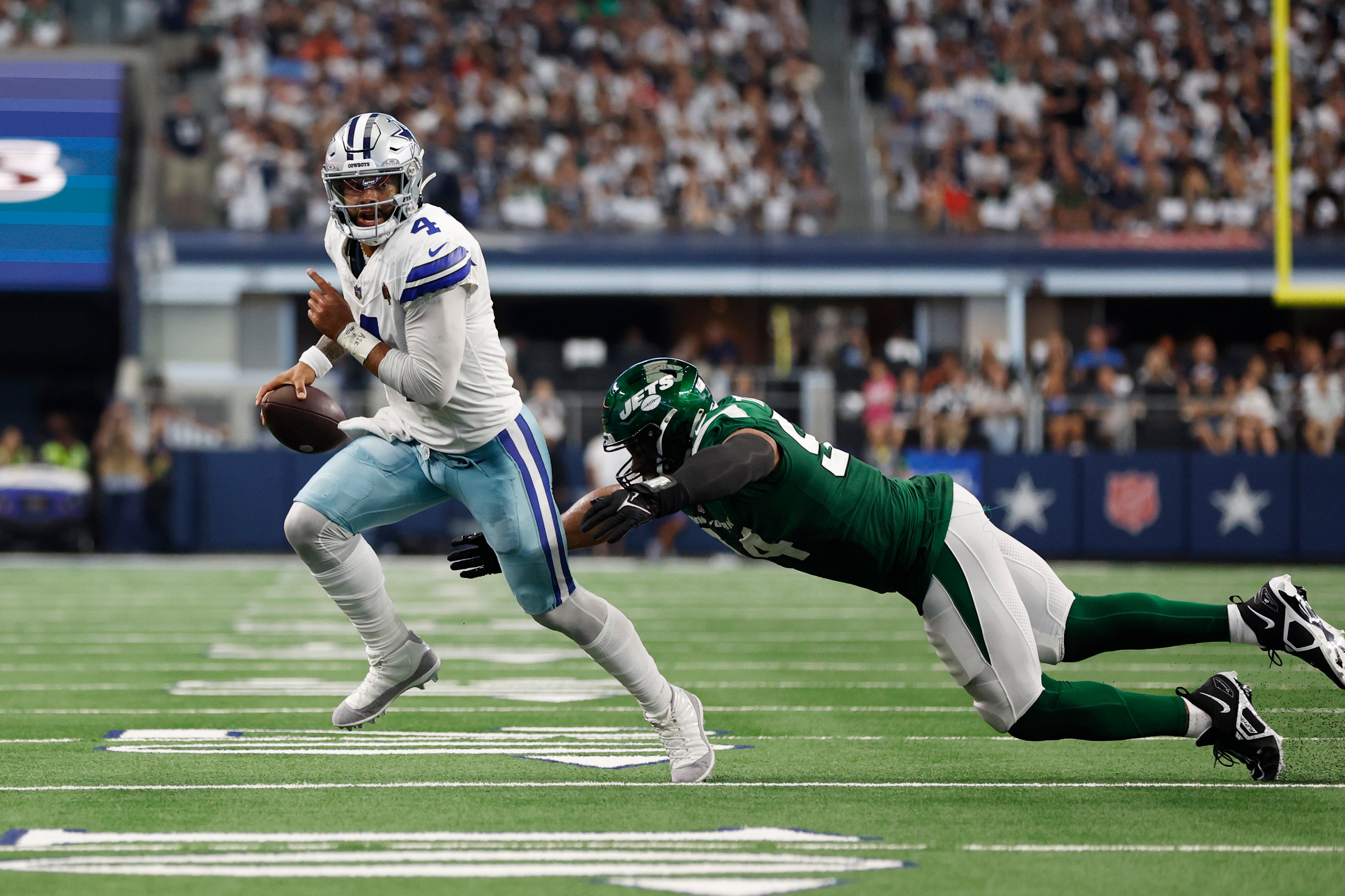 Dallas Cowboys quarterback Dak Prescott (4) is tackled by New York Jets defensive end Solomon Thomas (94) in the second quarter at AT&T Stadium. Mandatory Credit: Tim Heitman-USA TODAY Sports
