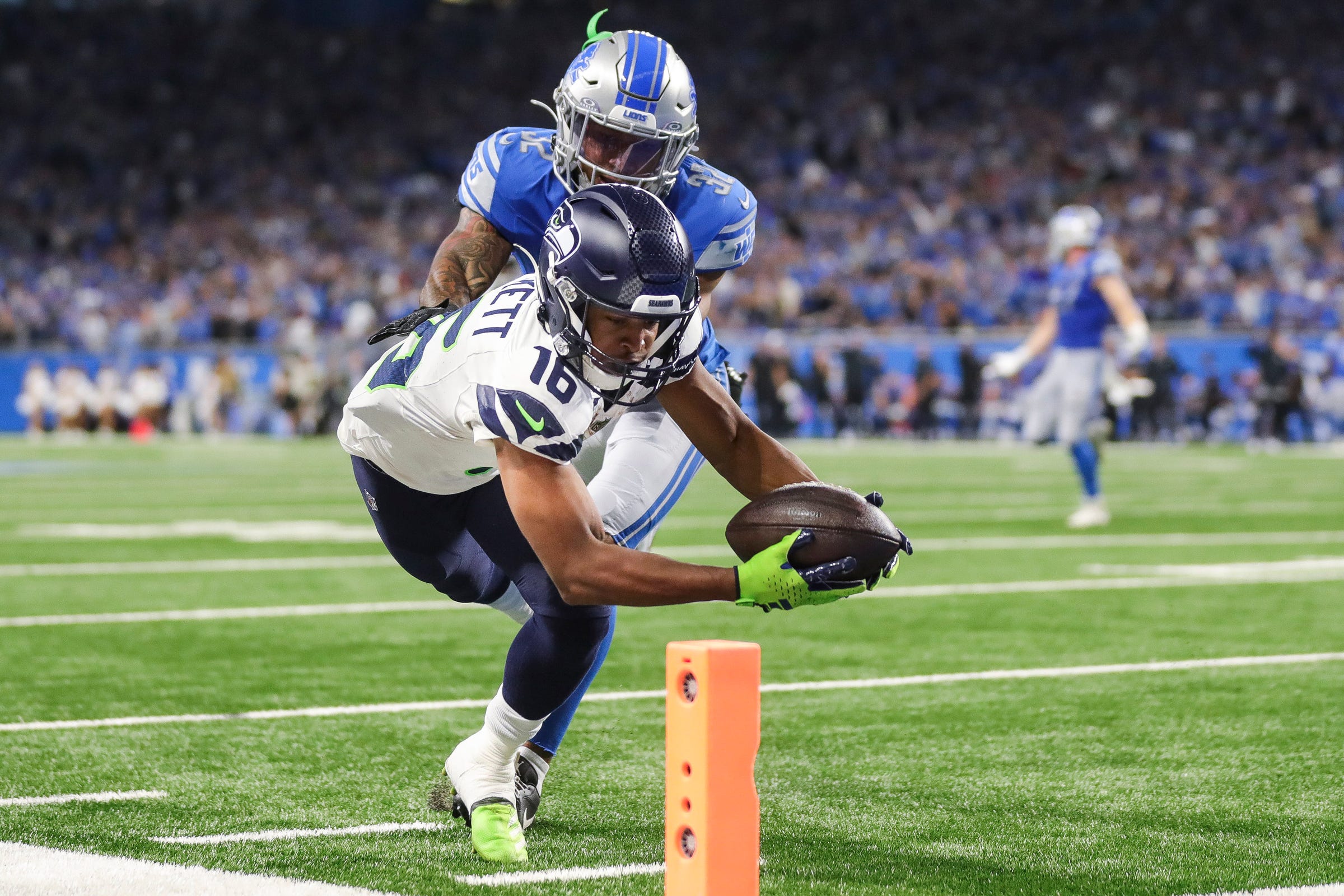 Seattle Seahawks wide receiver Tyler Lockett (16) makes a catch for a touchdown against Detroit Lions safety Brian Branch (32) during overtime at Ford Field in Detroit on Sunday, Sept. 17, 2023.