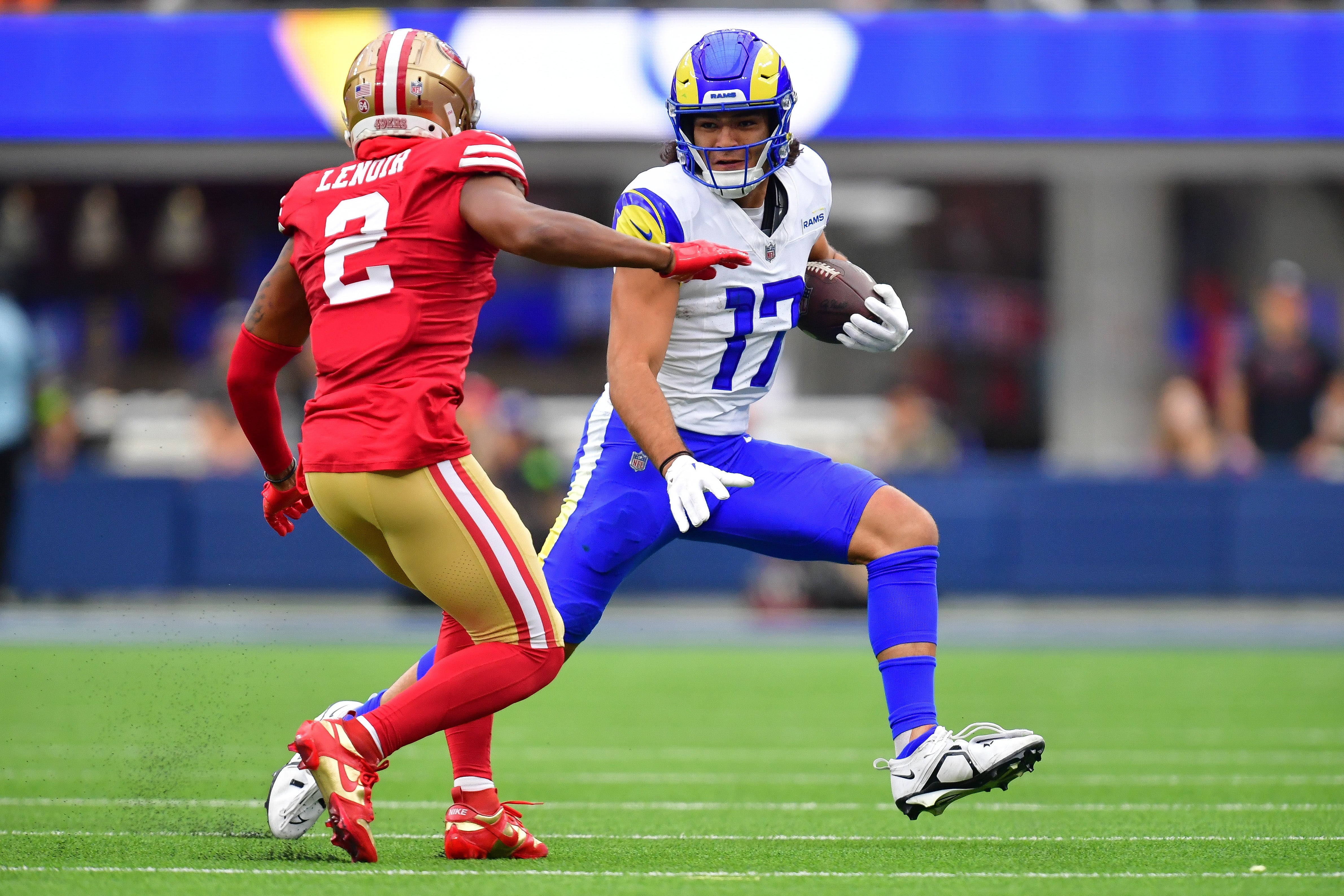 Sep 17, 2023; Inglewood, California, USA; Los Angeles Rams wide receiver Puka Nacua (17) runs the ball against San Francisco 49ers cornerback Deommodore Lenoir (2) during the first half at SoFi Stadium. Mandatory Credit: Gary A. Vasquez-USA TODAY Sports