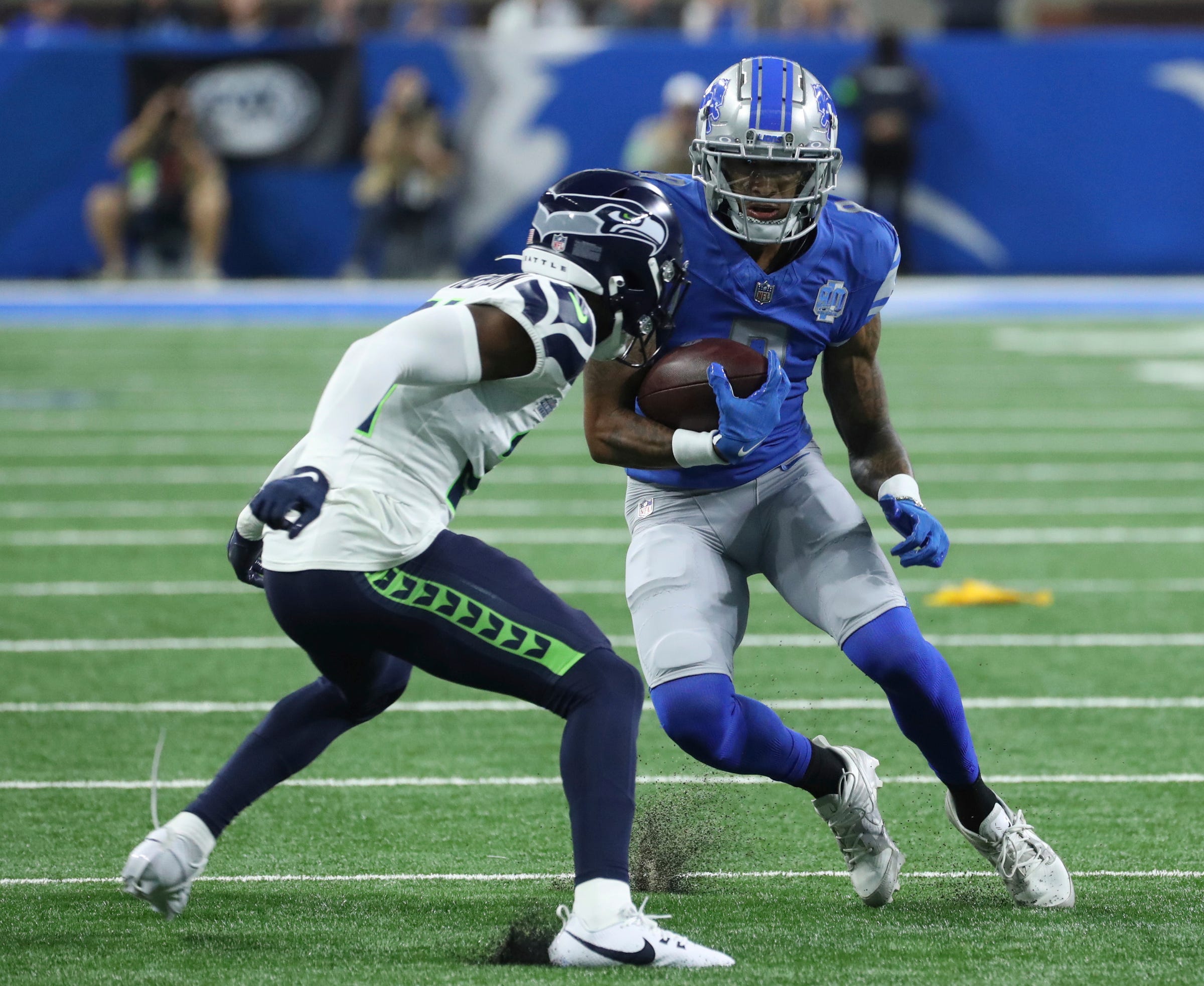 Detroit Lions wide receiver Josh Reynolds (8) makes a catch against Seattle Seahawks cornerback Devon Witherspoon (21) during the first half at Ford Field, Sunday, Sept. 17, 2023.