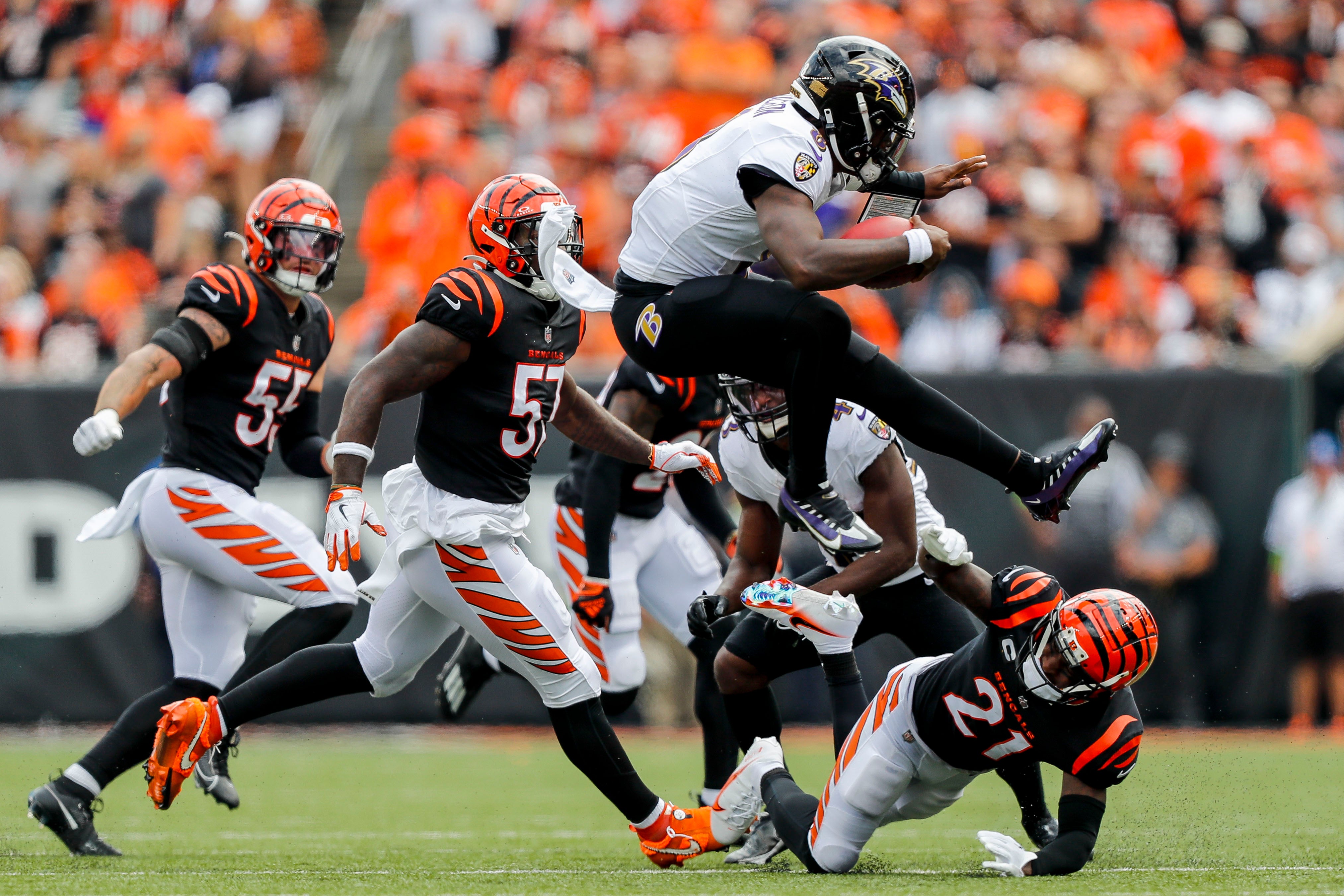 Sep 17, 2023; Cincinnati, Ohio, USA; Baltimore Ravens quarterback Lamar Jackson (8) jumps over Cincinnati Bengals cornerback Mike Hilton (21) during the first half at Paycor Stadium. Mandatory Credit: Katie Stratman-USA TODAY Sports