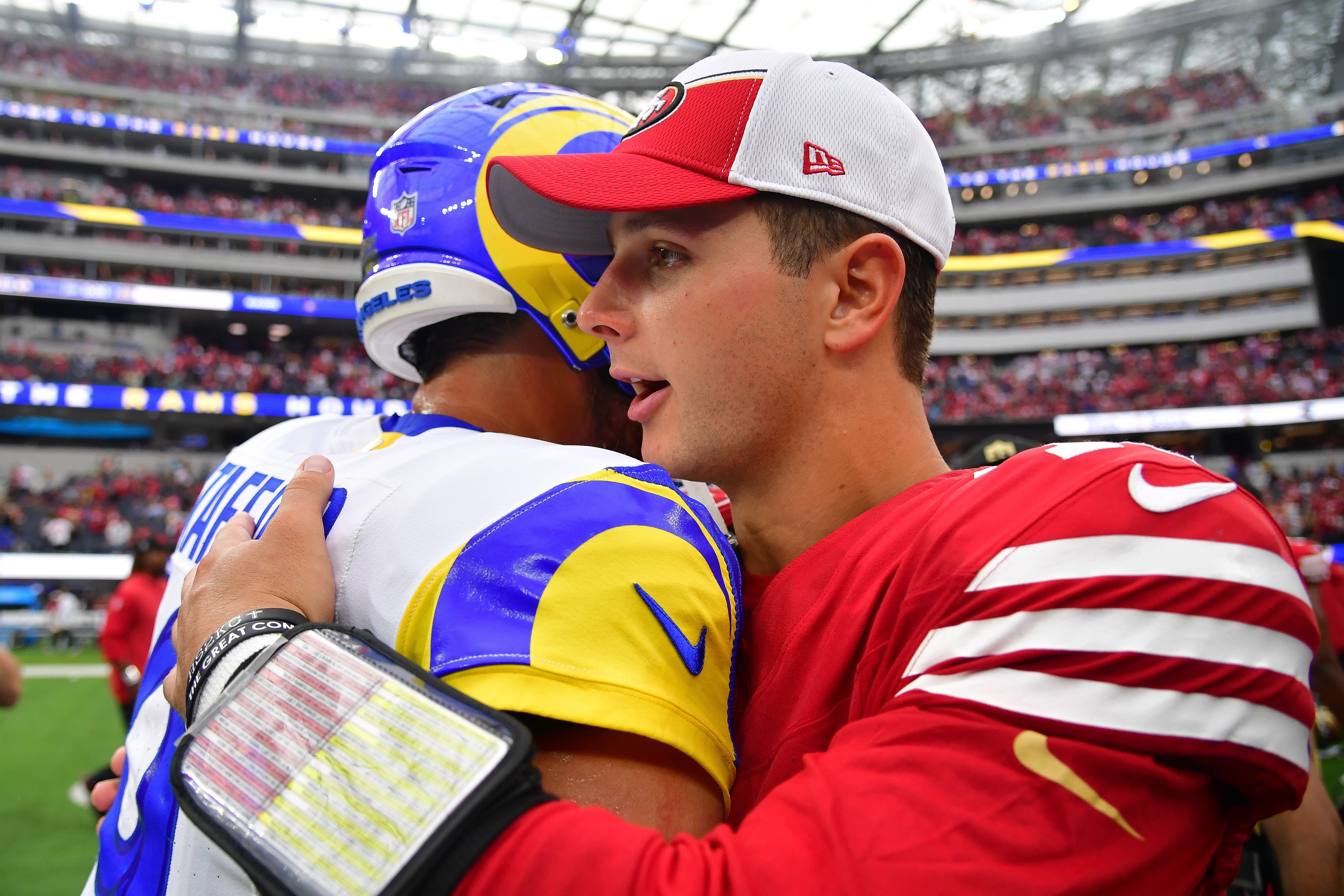 Sep 17, 2023; Inglewood, California, USA; San Francisco 49ers quarterback Brock Purdy (13) meets with Los Angeles Rams quarterback Matthew Stafford (9) following the victory at SoFi Stadium. Mandatory Credit: Gary A. Vasquez-USA TODAY Sports.