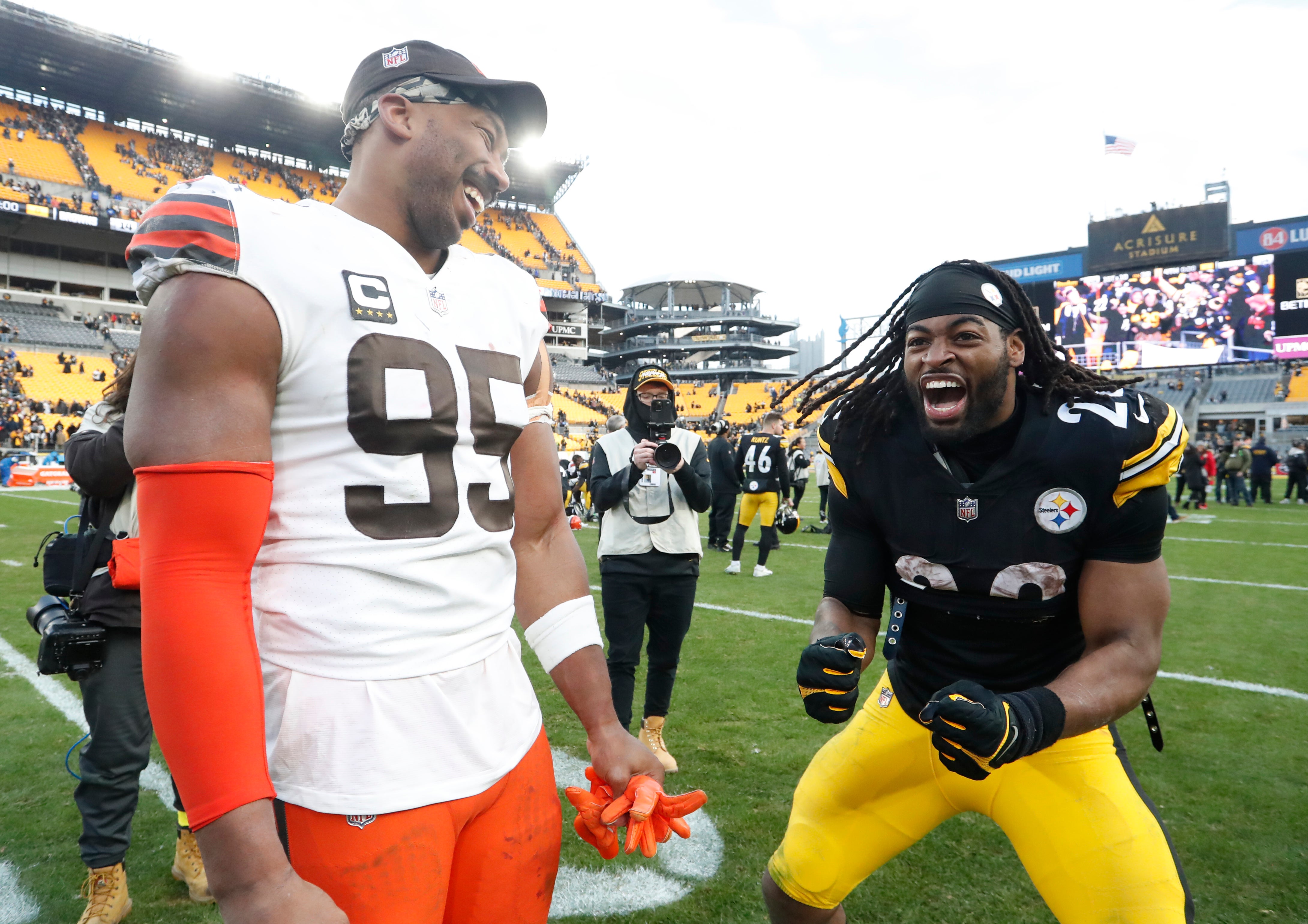Jan 8, 2023; Pittsburgh, Pennsylvania, USA; Cleveland Browns defensive end Myles Garrett (95) and Pittsburgh Steelers running back Najee Harris (22) share a laugh on the field after their game at Acrisure Stadium. Pittsburgh won 28-14. Mandatory Credit: Charles LeClaire-USA TODAY Sports